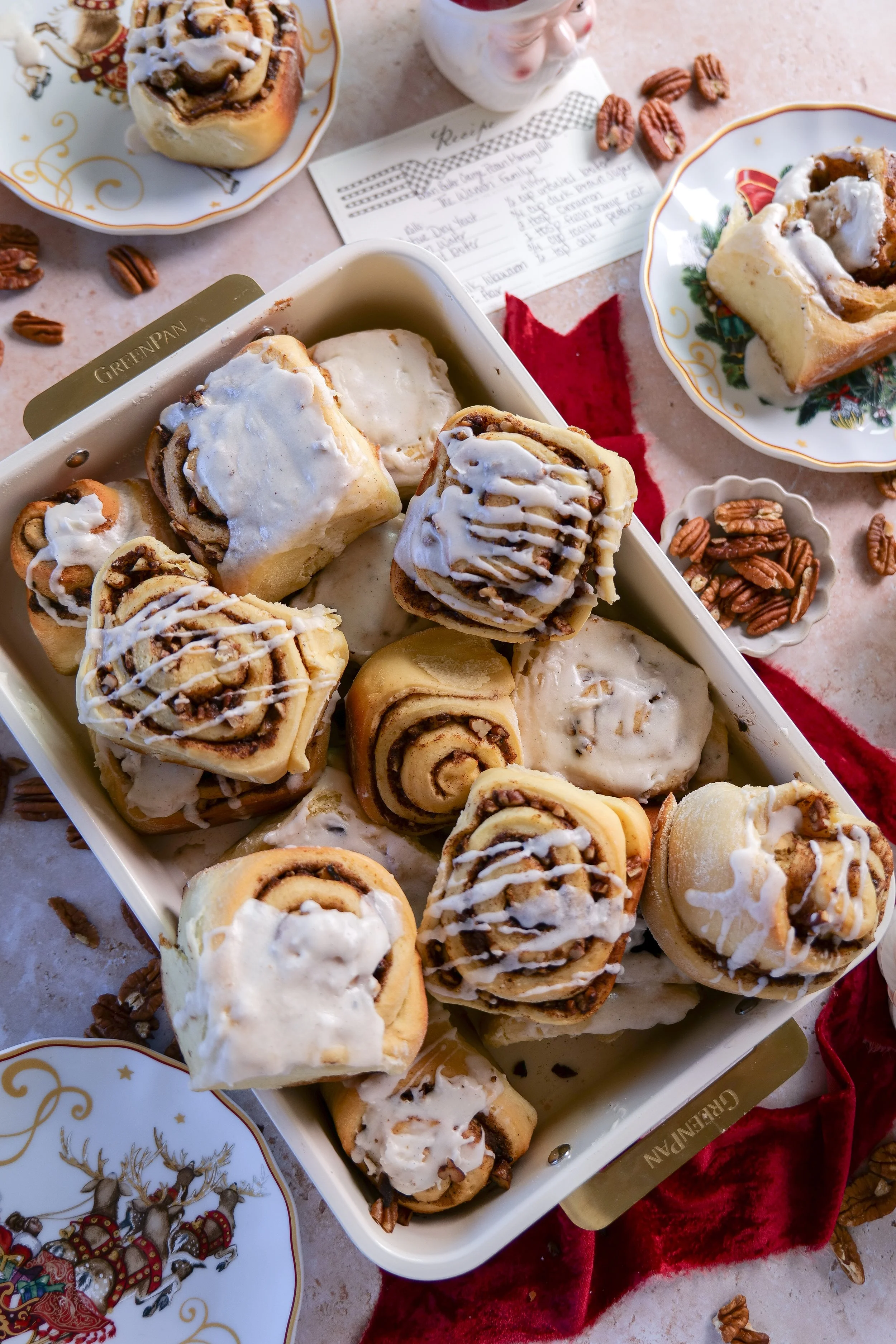 Freshly baked brown butter orange pecan cinnamon rolls topped with creamy vanilla bean glaze.