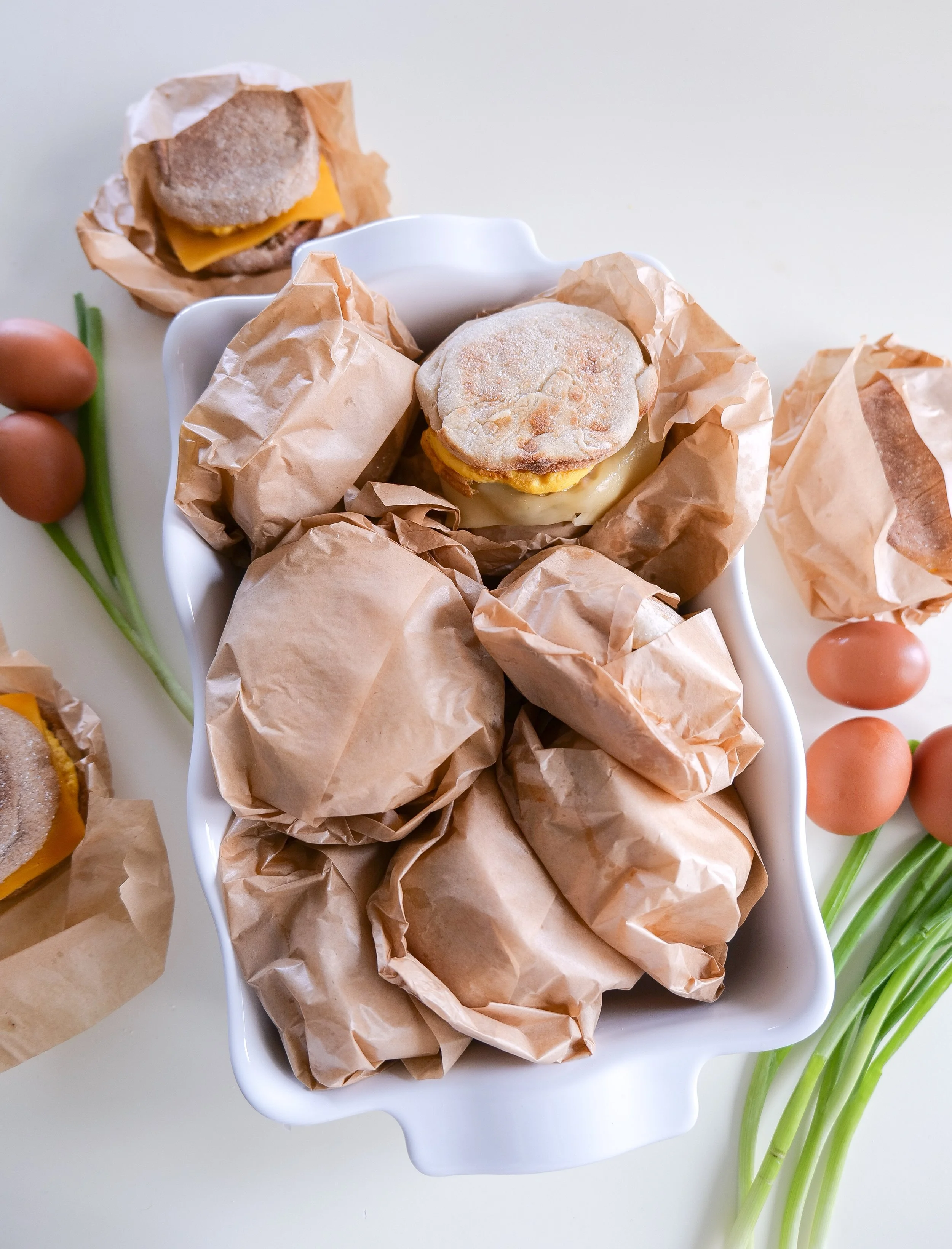 Homemade sausage English muffin breakfast sandwiches with egg and melted cheese for an easy make-ahead breakfast.
