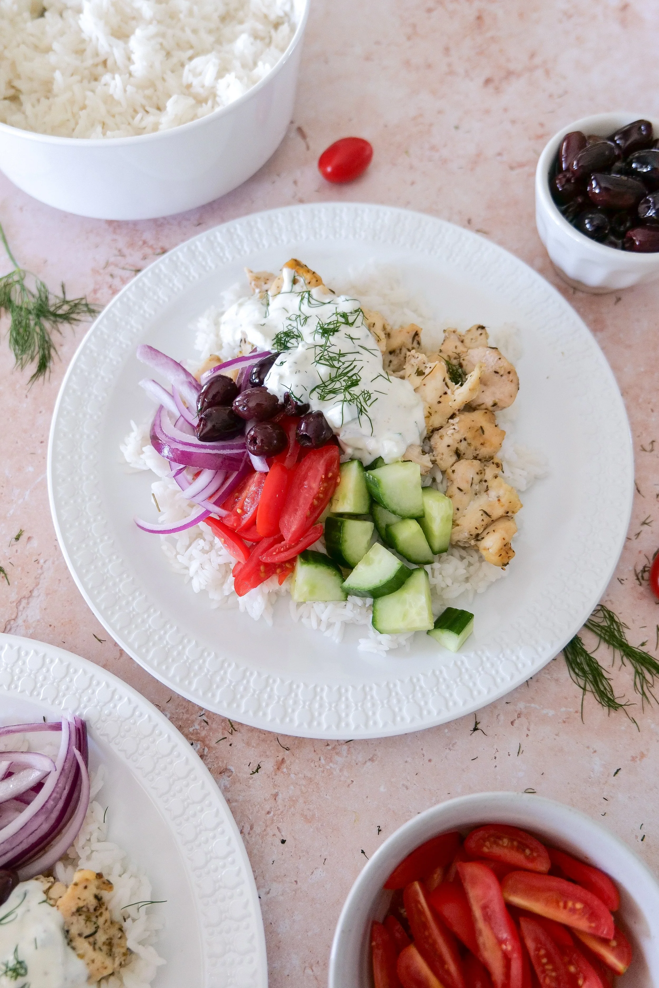 Greek chicken and rice bowl with herb chicken, jasmine rice, cucumber, tomatoes, Kalamata olives and homemade tzatziki.