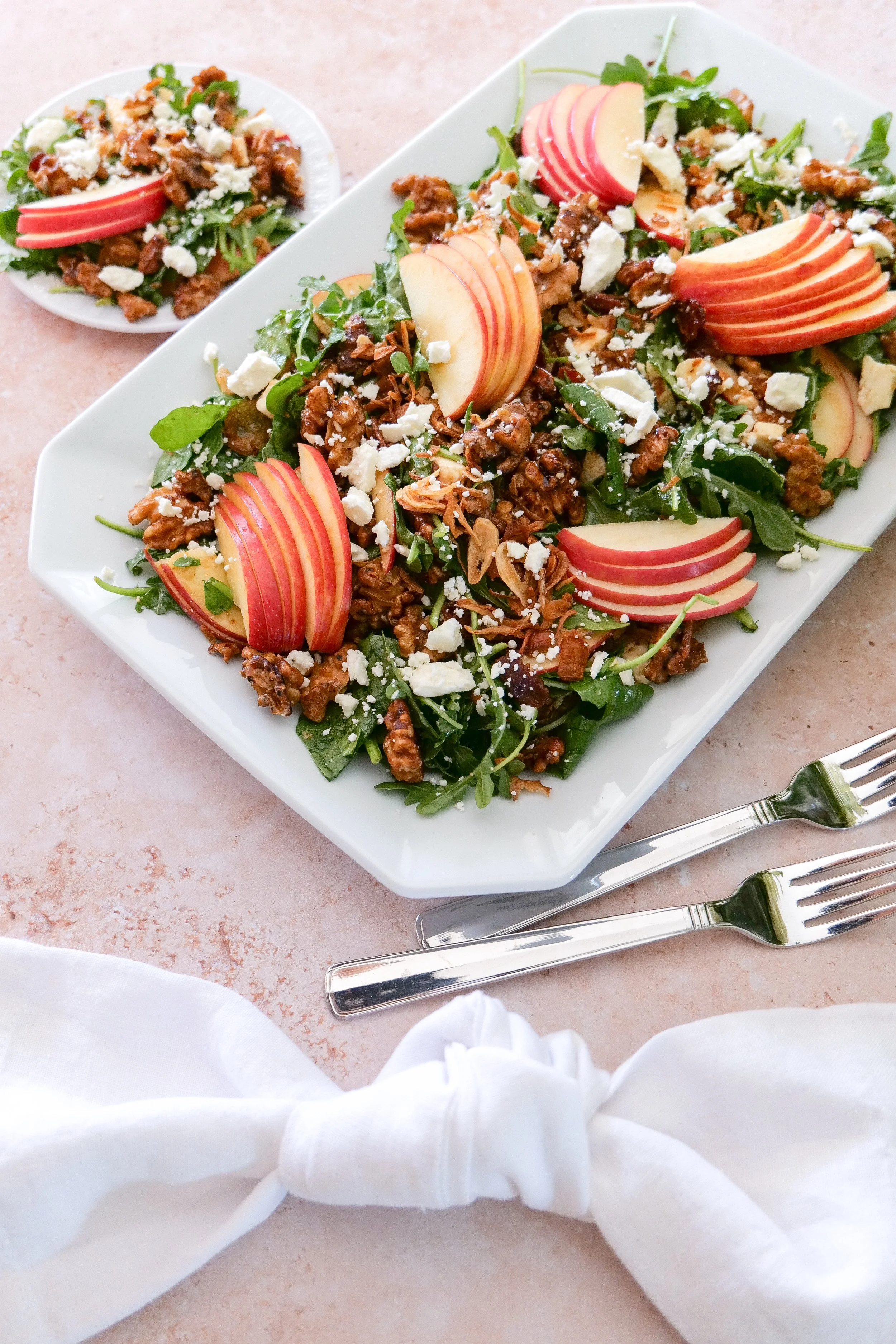 Apple salad with maple-glazed walnuts, crumbled feta, bacon and spinach and arugula.