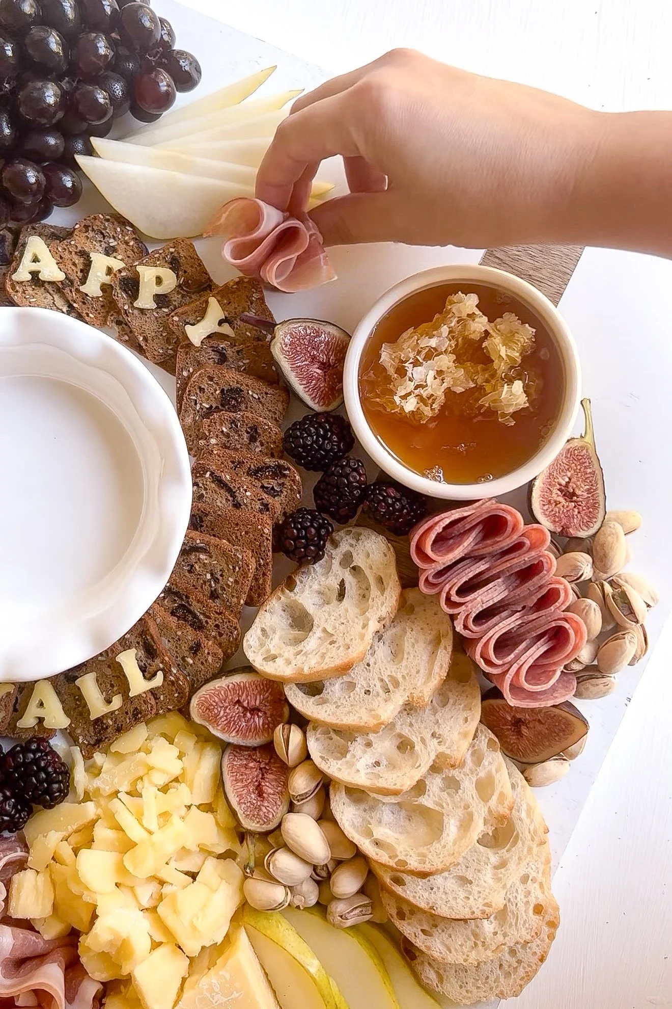 Charcuterie board with fresh figs, pears, cheese and crackers