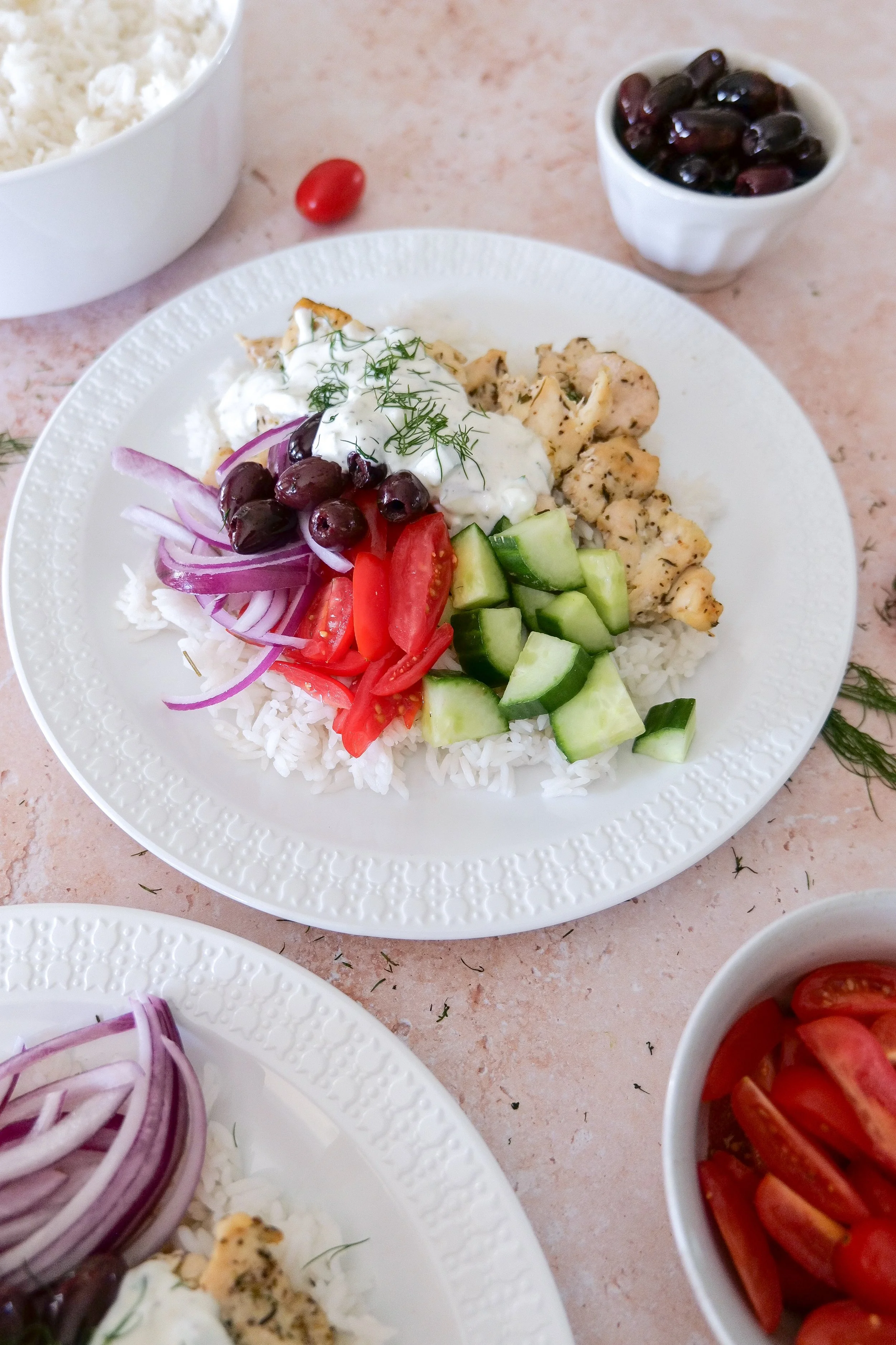 Chicken and jasmine rice bowl finished with cucumber, tomatoes, olives and homemade tzatziki sauce.