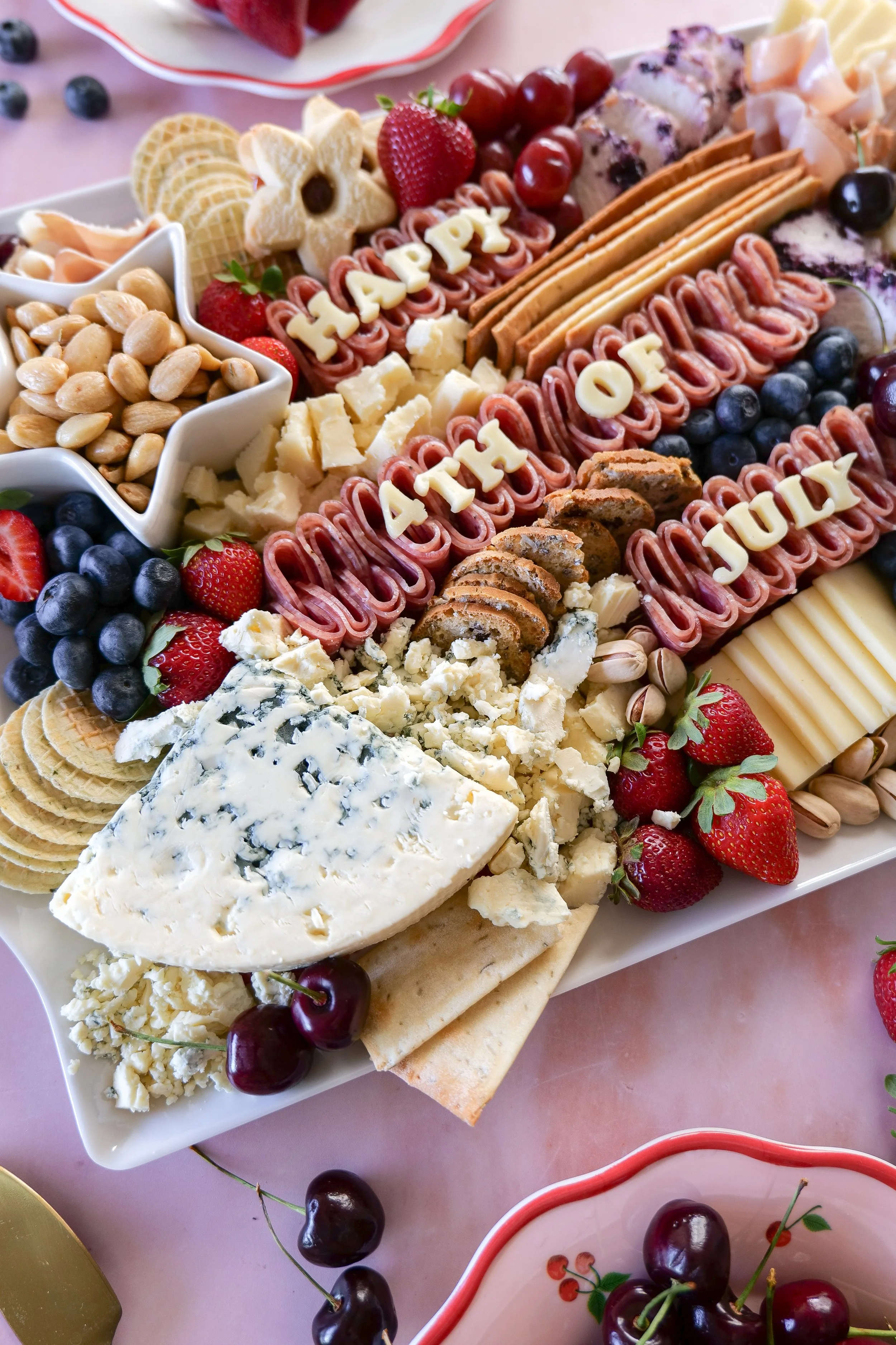 Red, white, and blue party food displayed on an All-American charcuterie board.