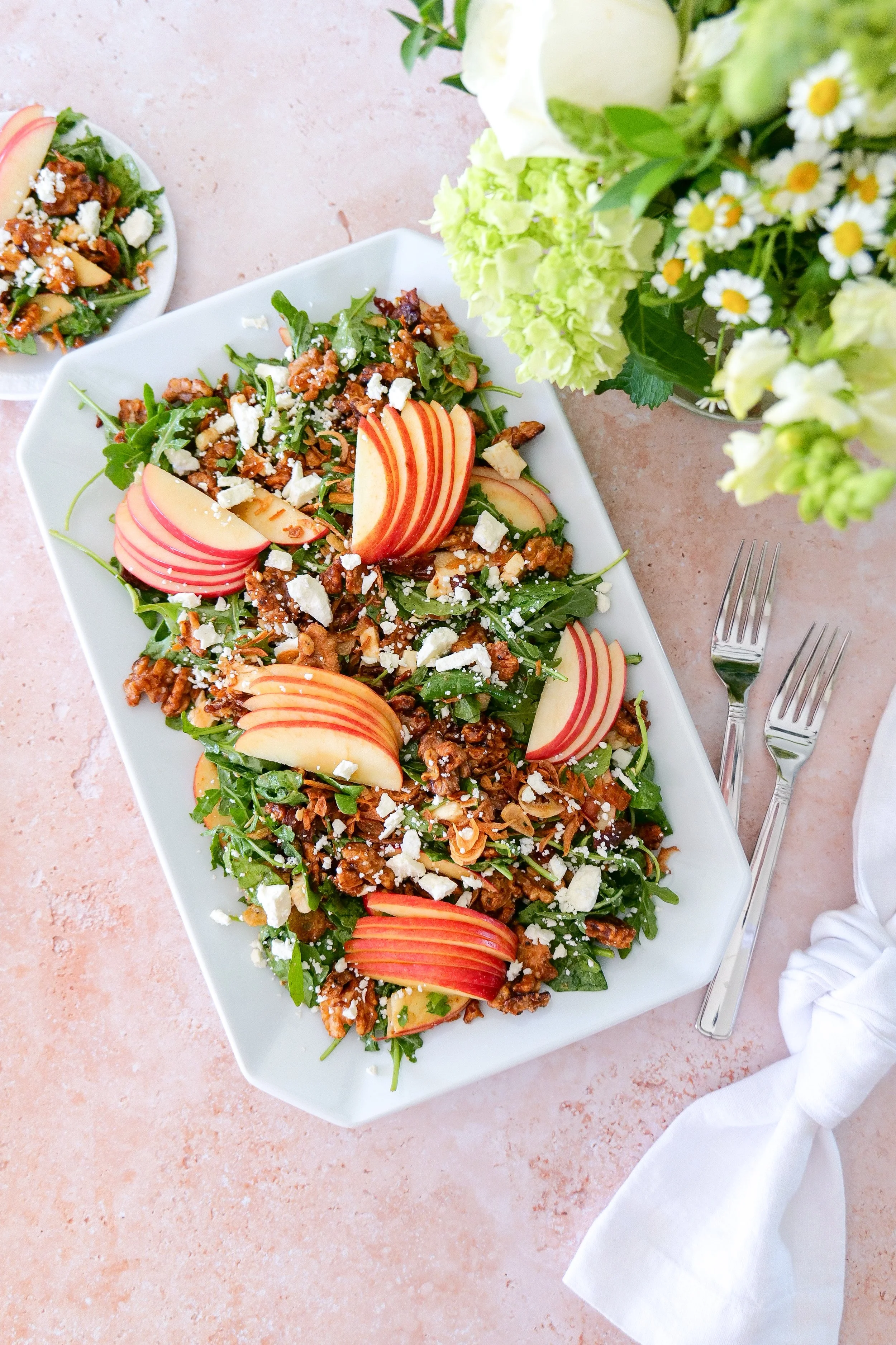 Maple bacon fall salad with sliced apples, feta, maple walnuts and crispy shallots over spinach and arugula.