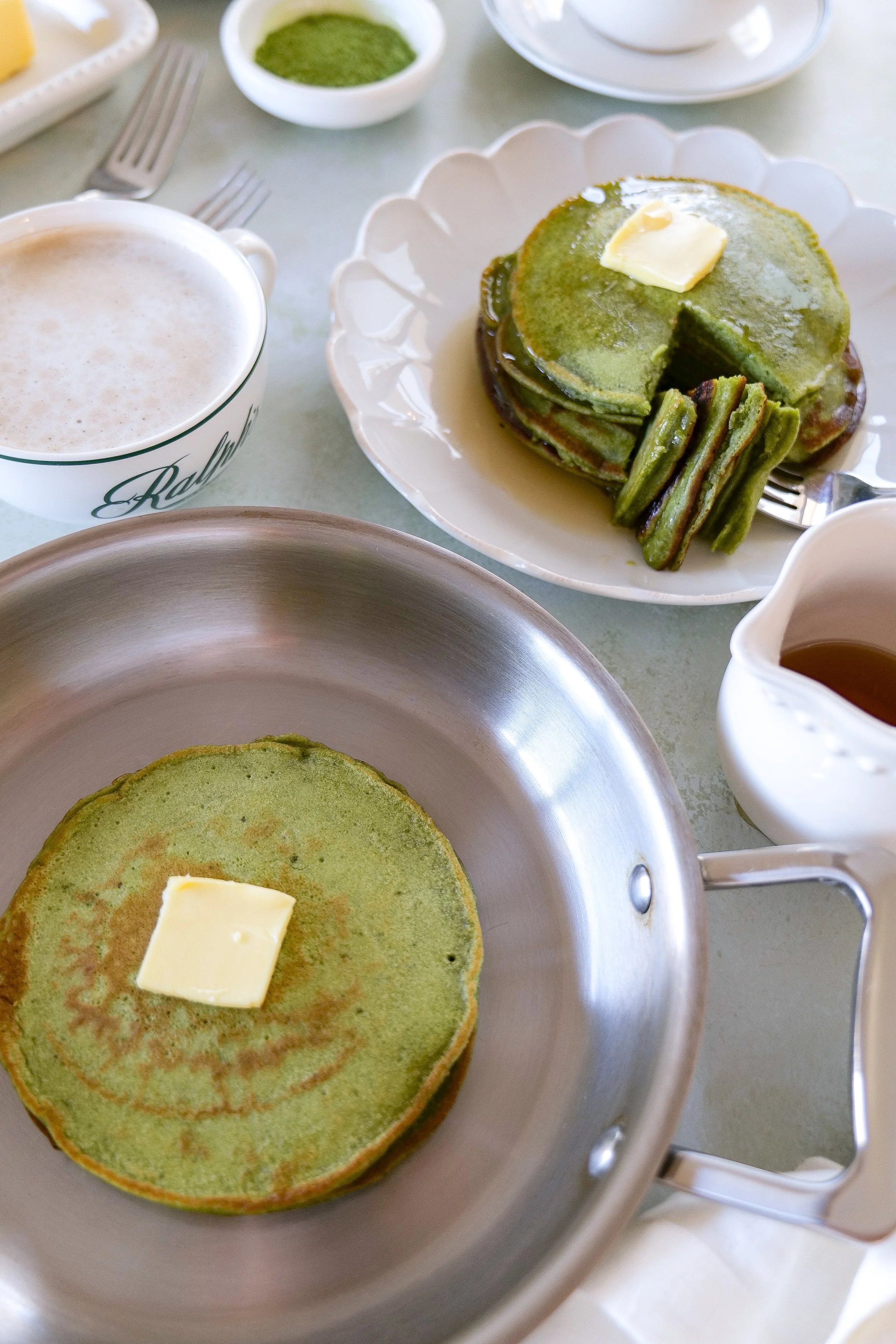 fluffy matcha sourdough discard pancakes topped with butter melting