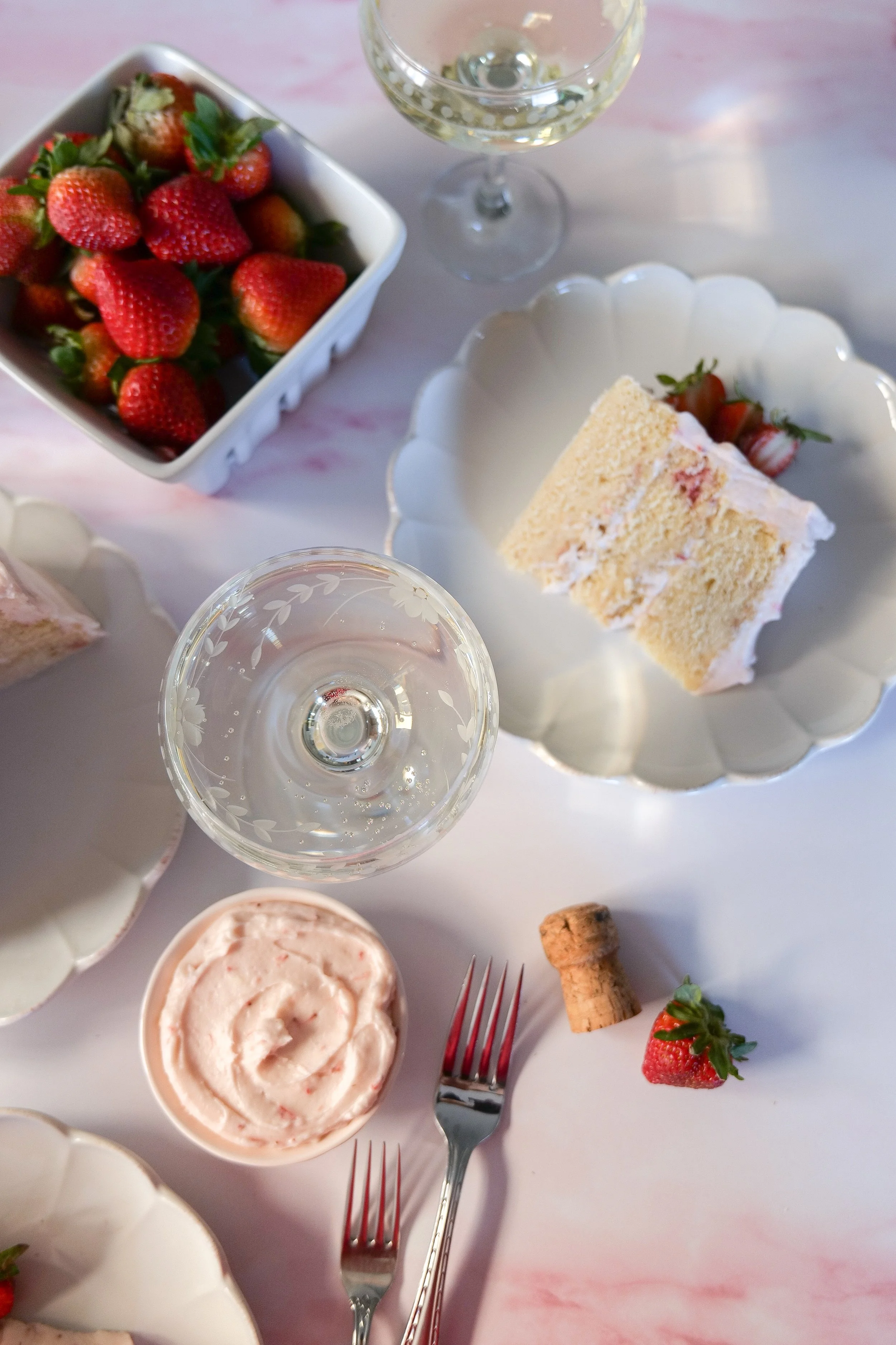 Homemade champagne cake finished with strawberry cream cheese frosting.