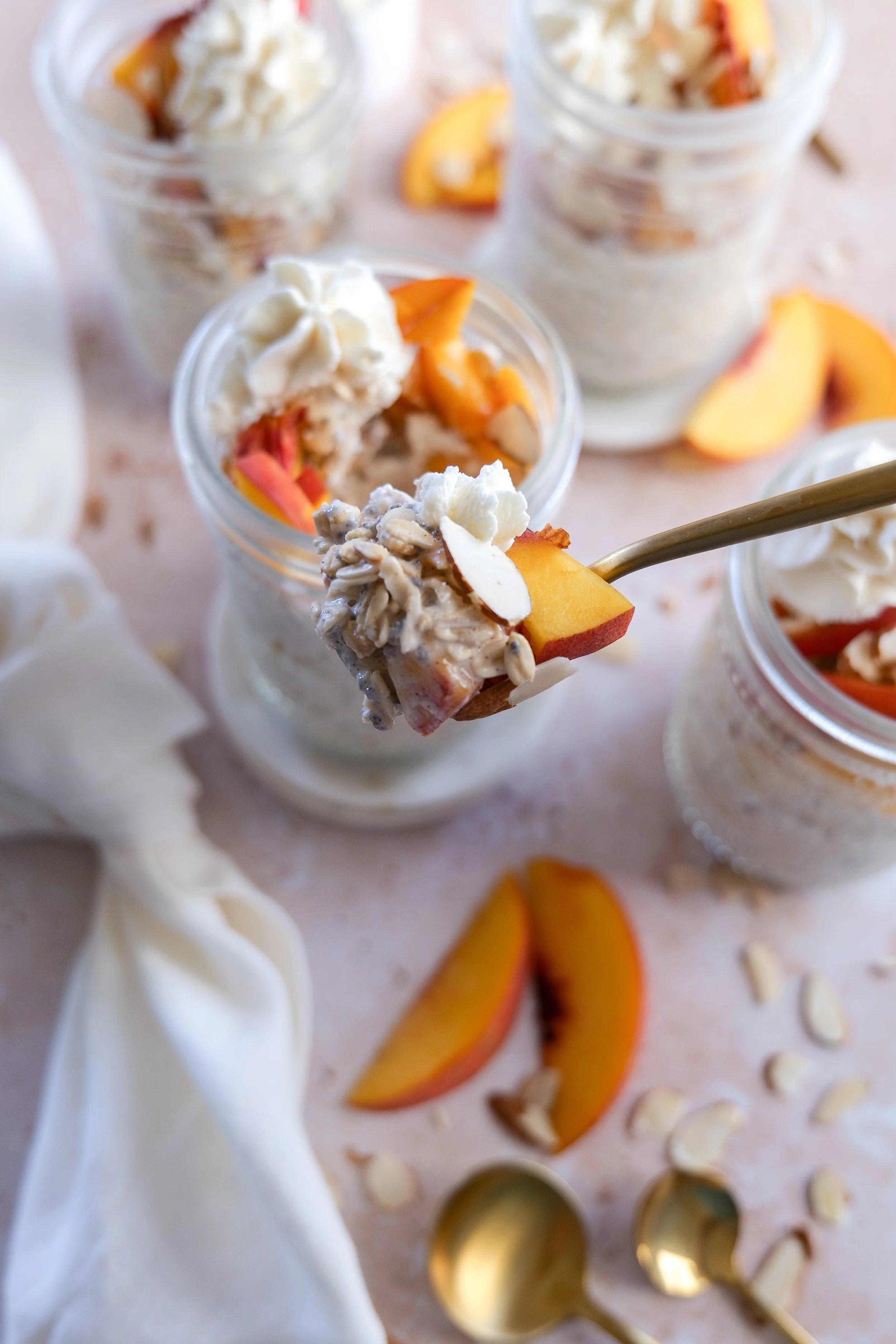 Fresh ripe peaches sliced on a cutting board for Peach Cobbler Overnight Oats.