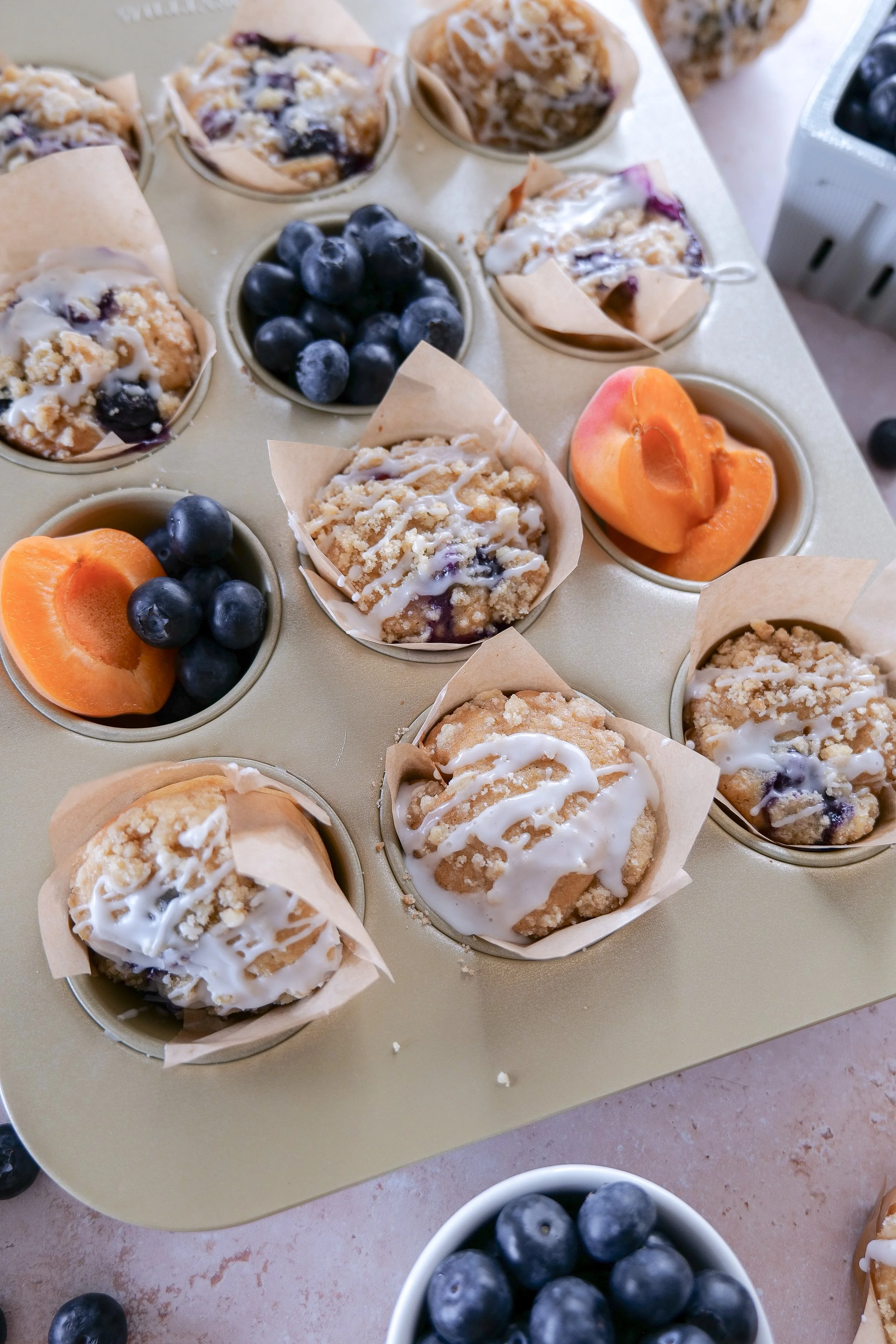 Split blueberry apricot muffin showing juicy fruit and tender crumb.
