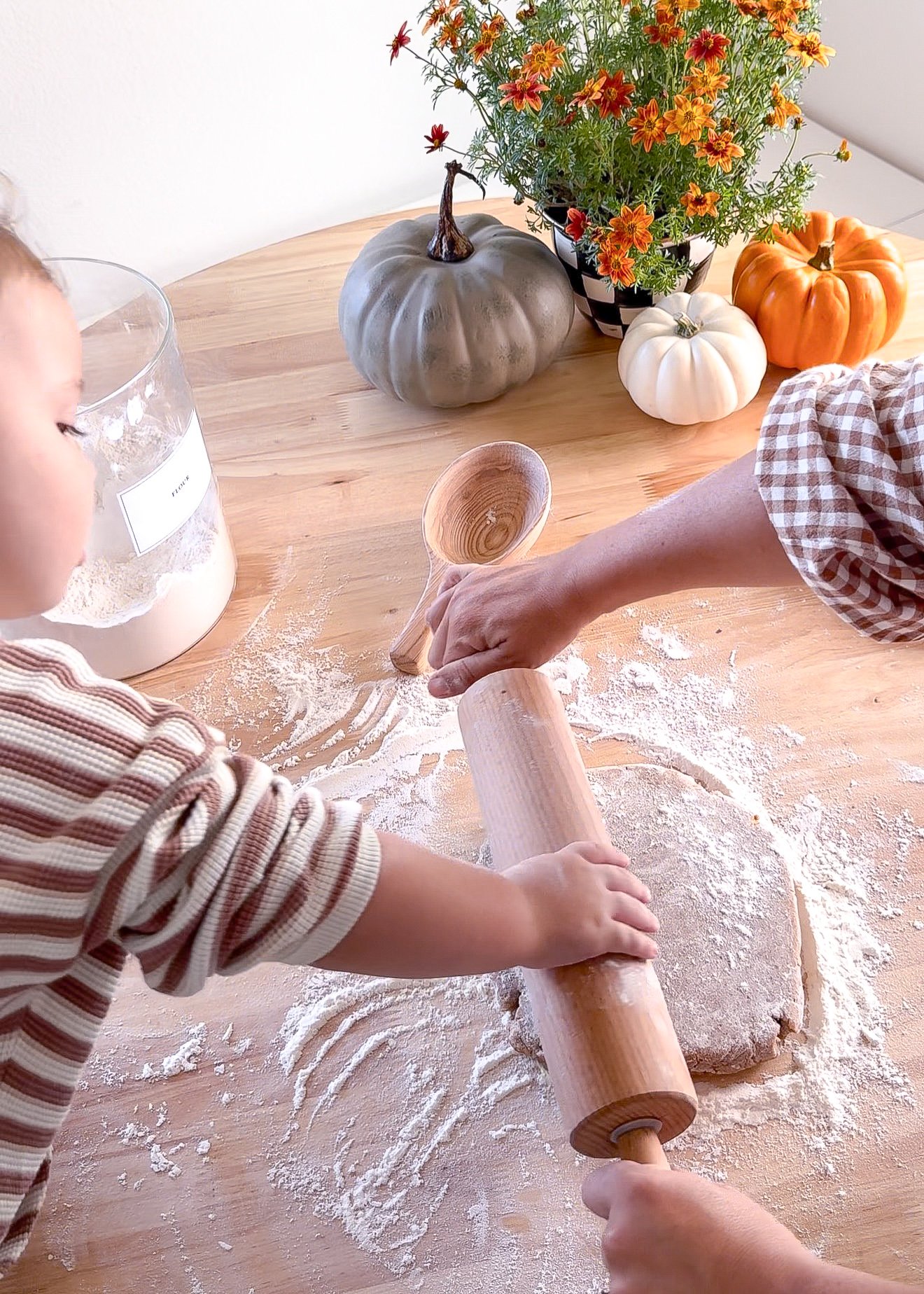 Pumpkin cookie dough being rolled out for fall cutout cookies