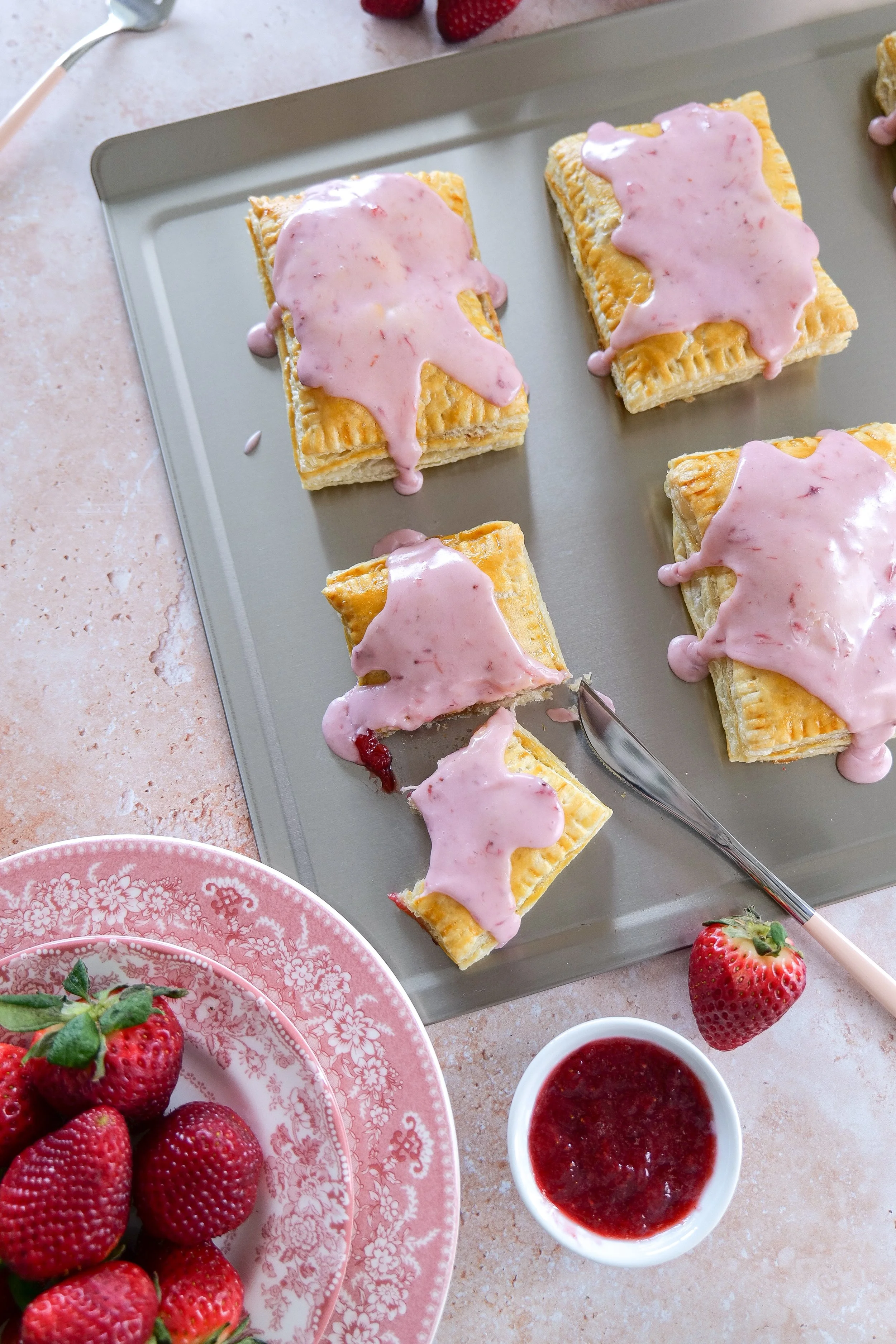 Strawberry Puff Pastry Pop Tart topped with strawberry cream glaze