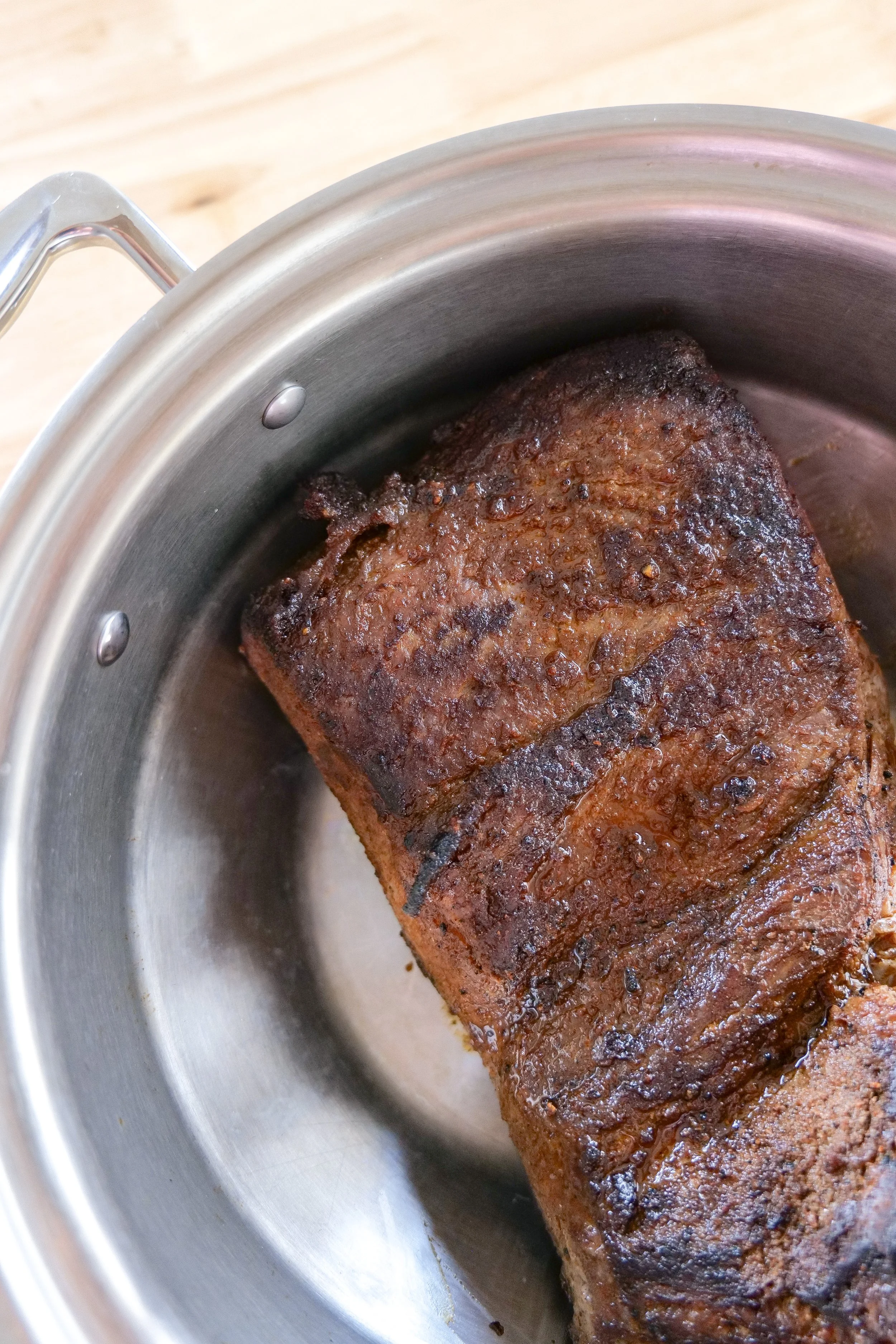 Slow-cooked beef brisket shredded into large tender pieces for serving.
