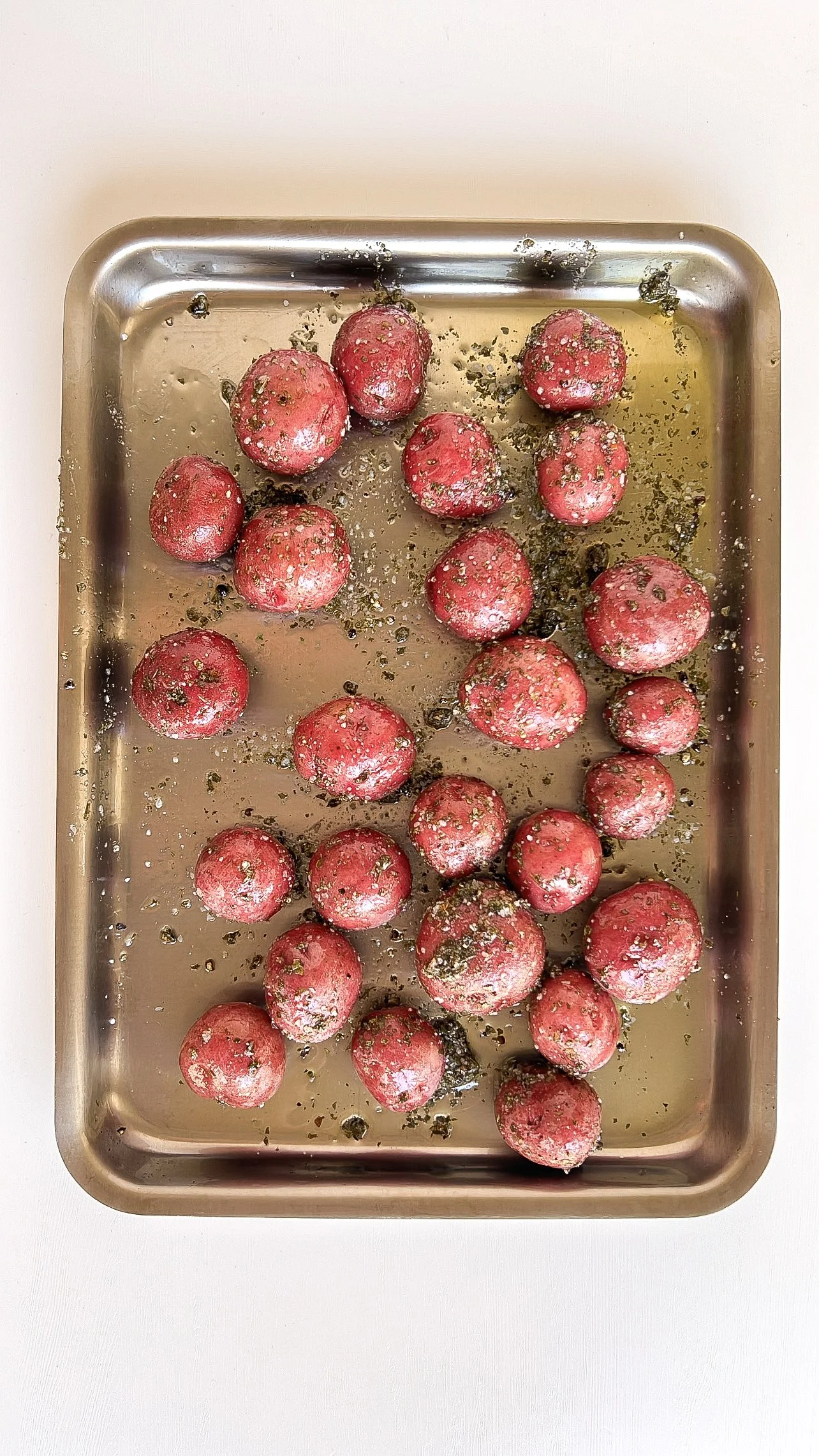 Baby red potatoes coated with olive oil, sea salt, black pepper, and parsley