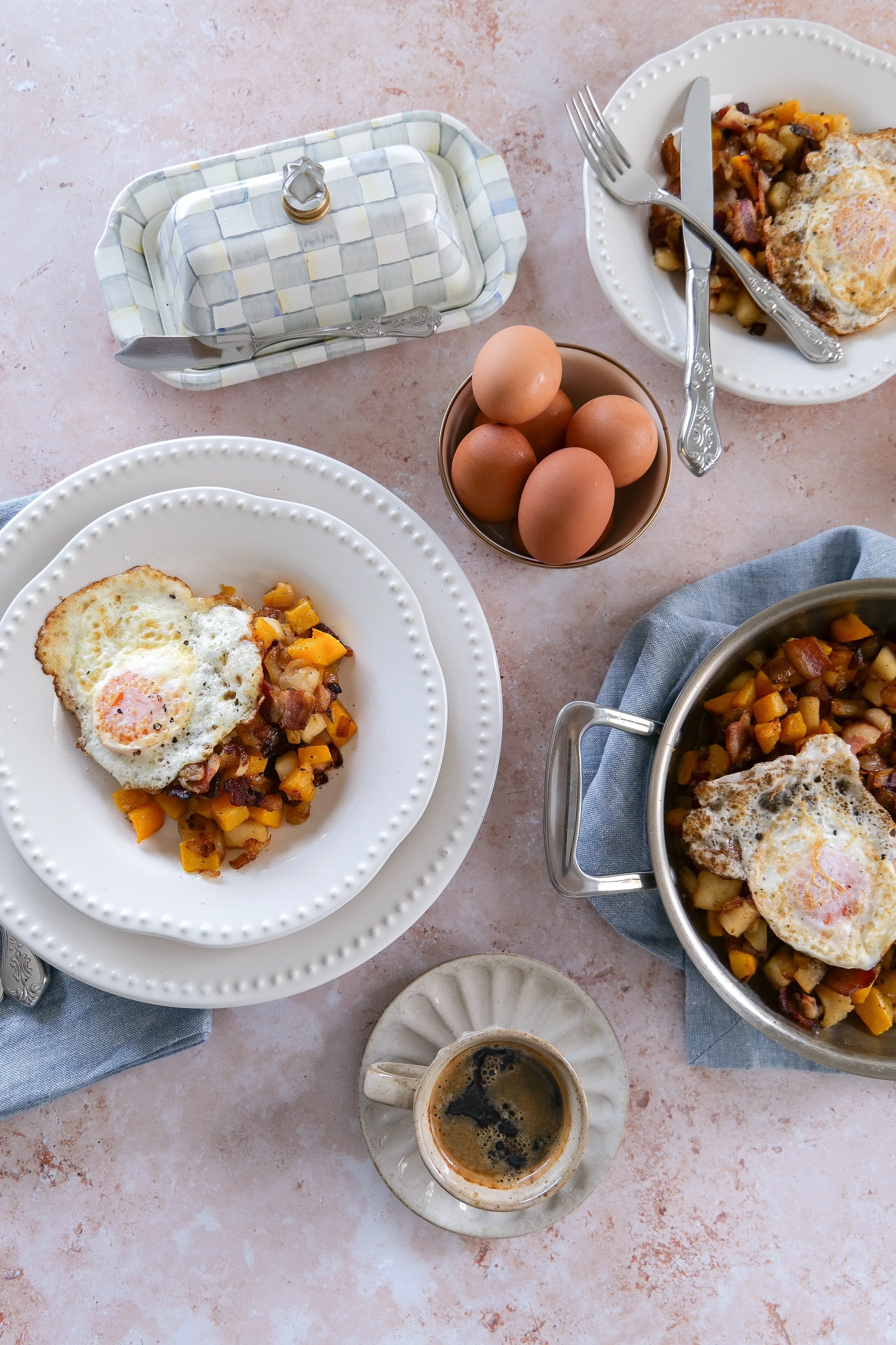 Savory butternut squash breakfast with bacon, onions, apples, and fried eggs.