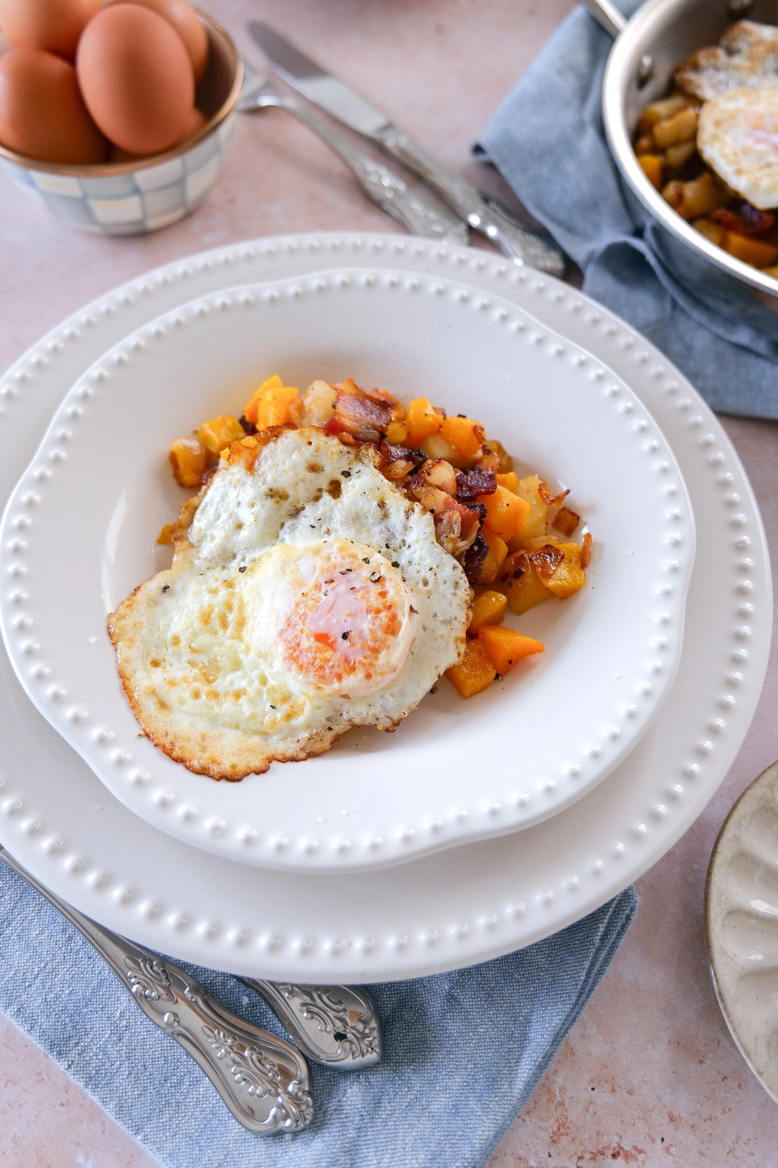 Butternut squash and apple breakfast skillet with crispy bacon and eggs.
