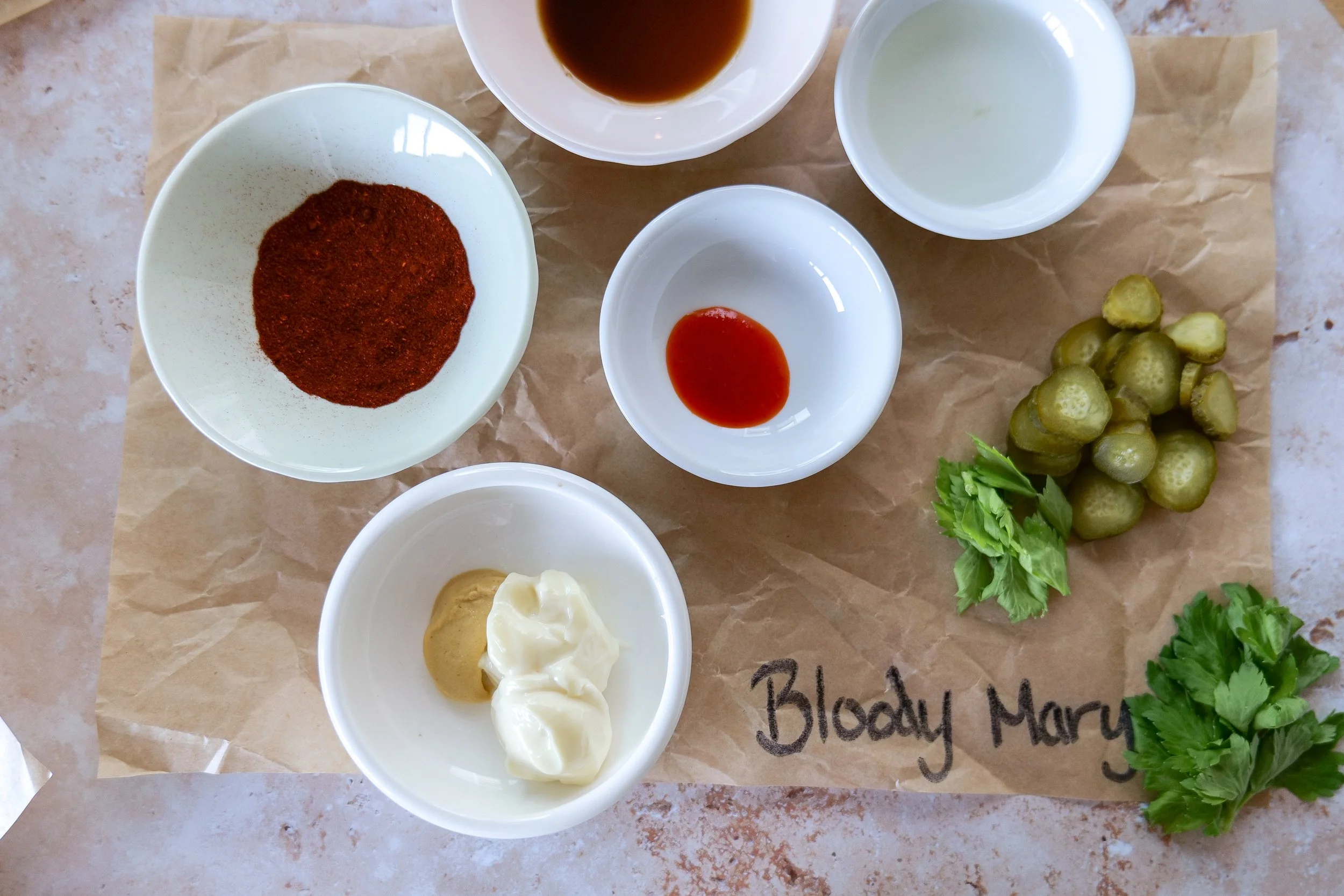Bloody Mary deviled eggs garnished with celery pickle and paprika