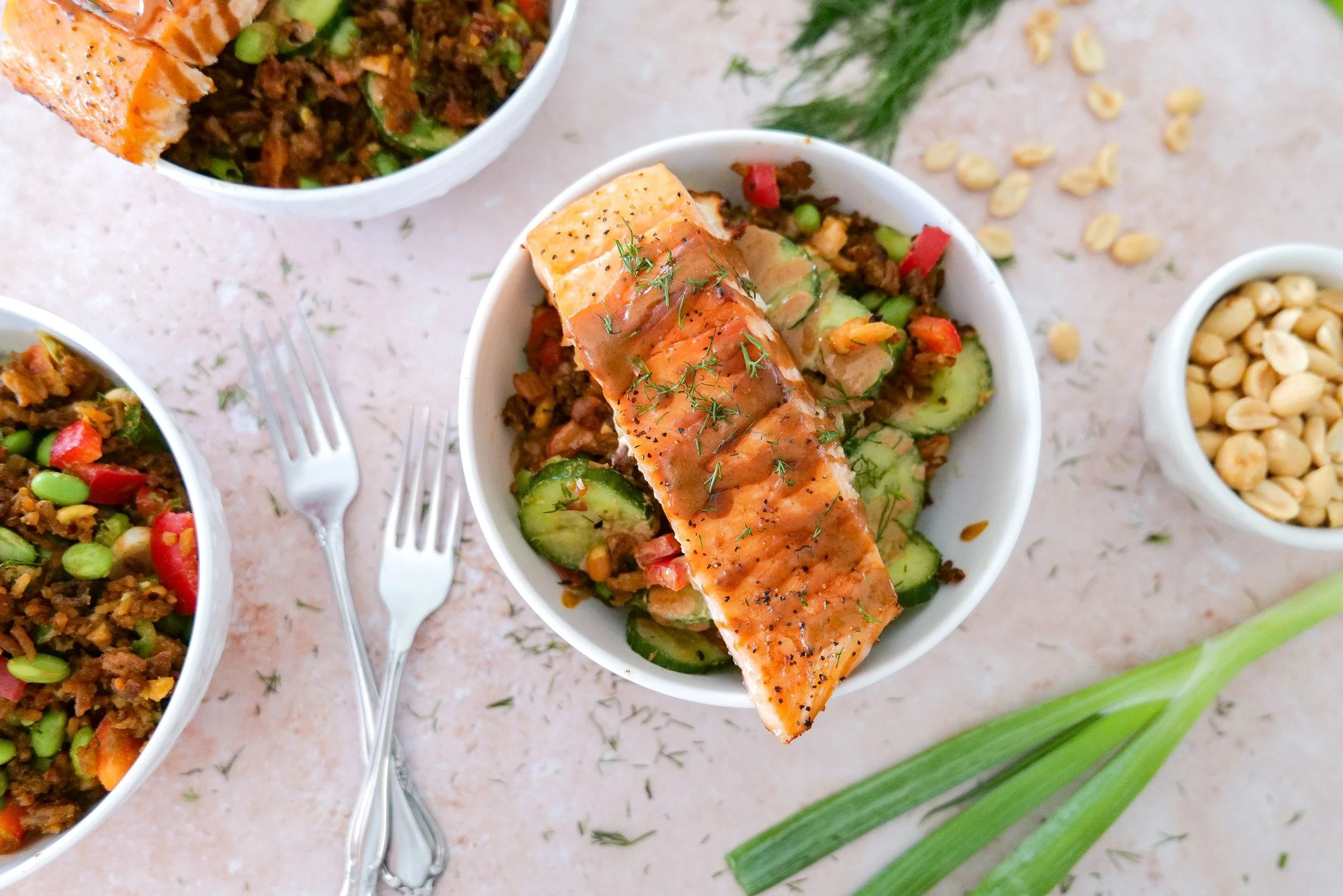 Crispy jasmine rice salad with salmon, edamame, avocado and fresh vegetables.