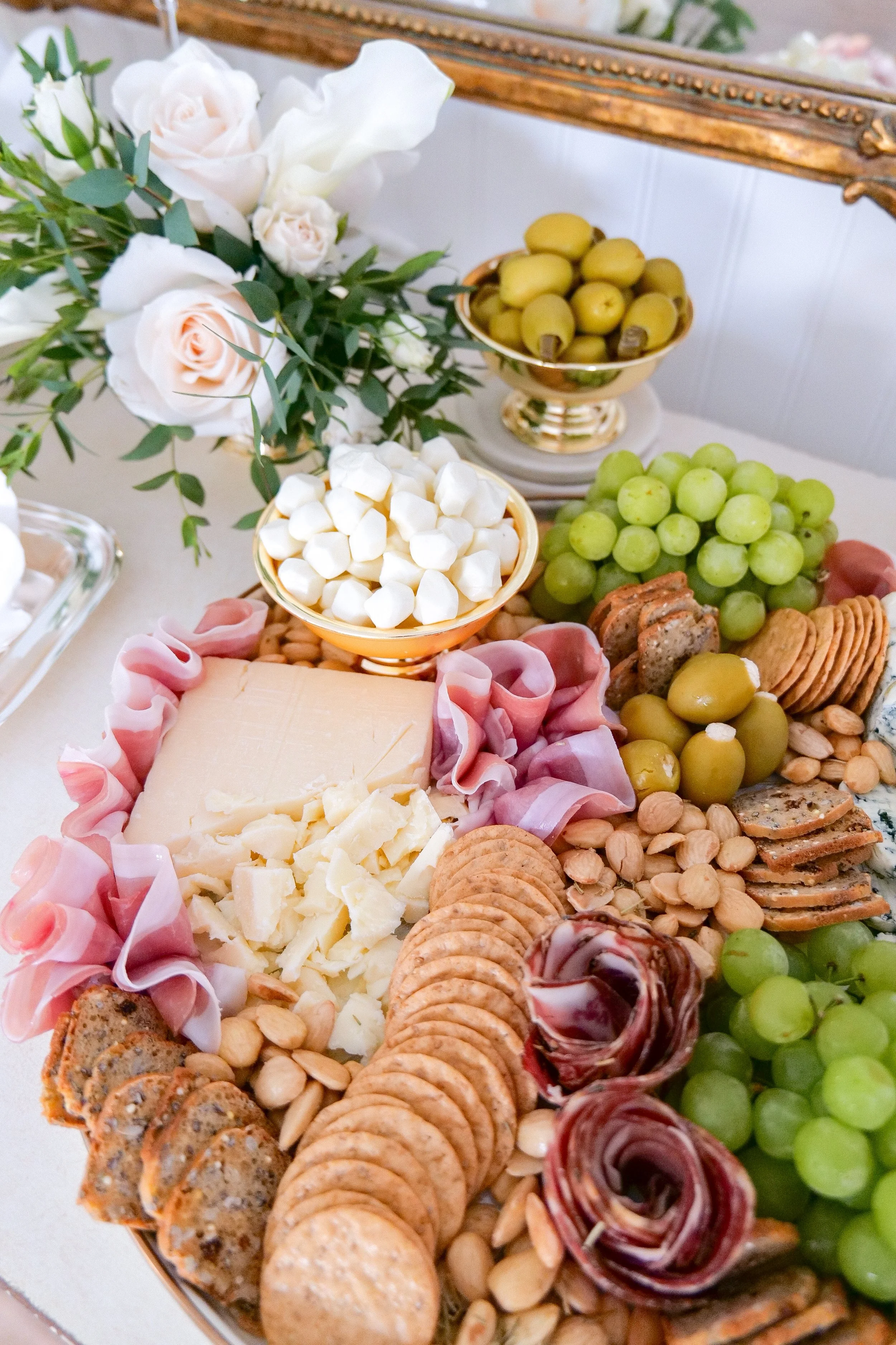 Summer appetizer board featuring cheeses, fruit, and seafood