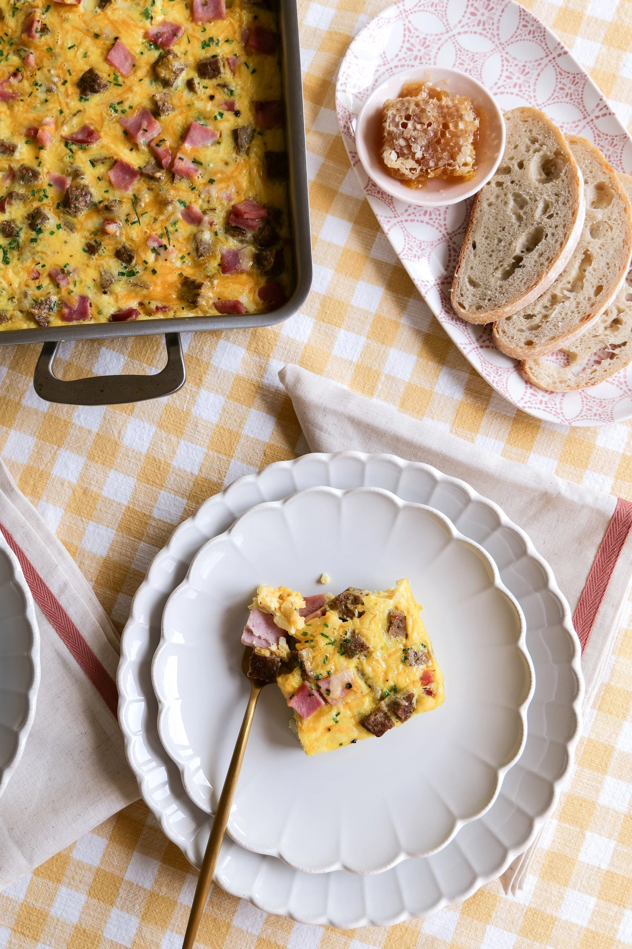 Hash brown breakfast casserole with sausage, eggs, and melted cheese.