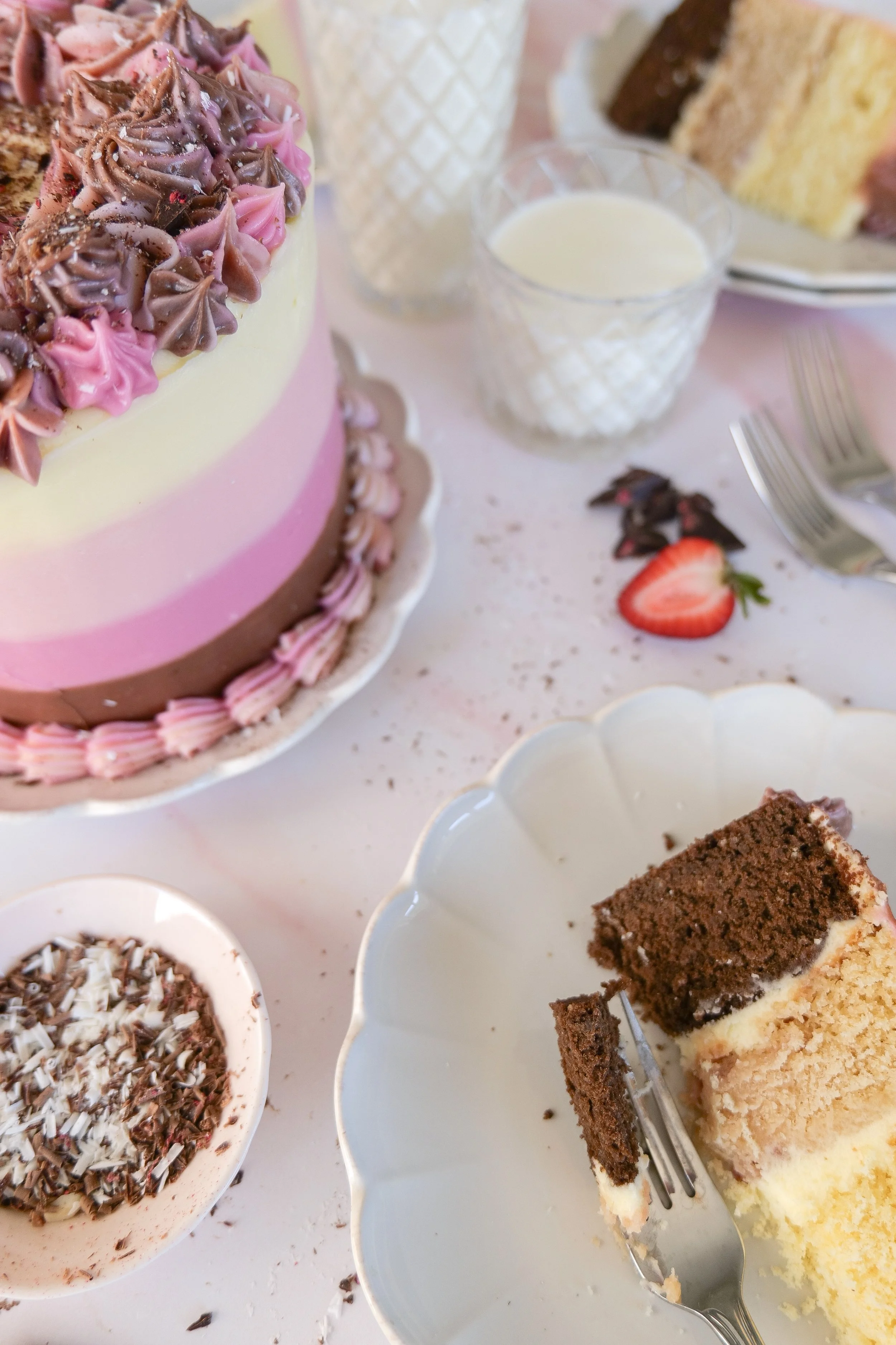 Homemade Neapolitan cake covered in smooth cream cheese frosting.