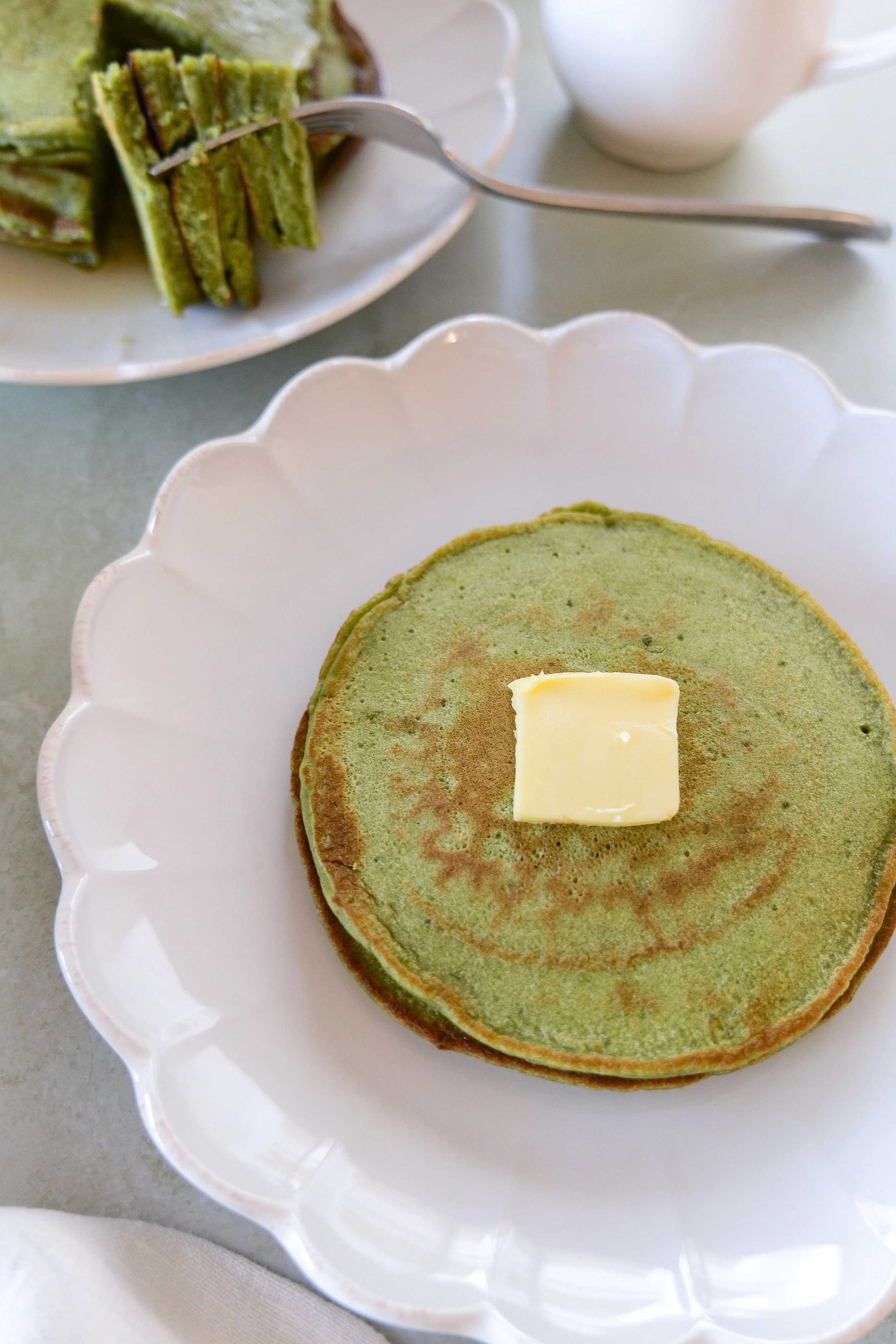 Golden-edged fluffy matcha pancakes made with sourdough discard
