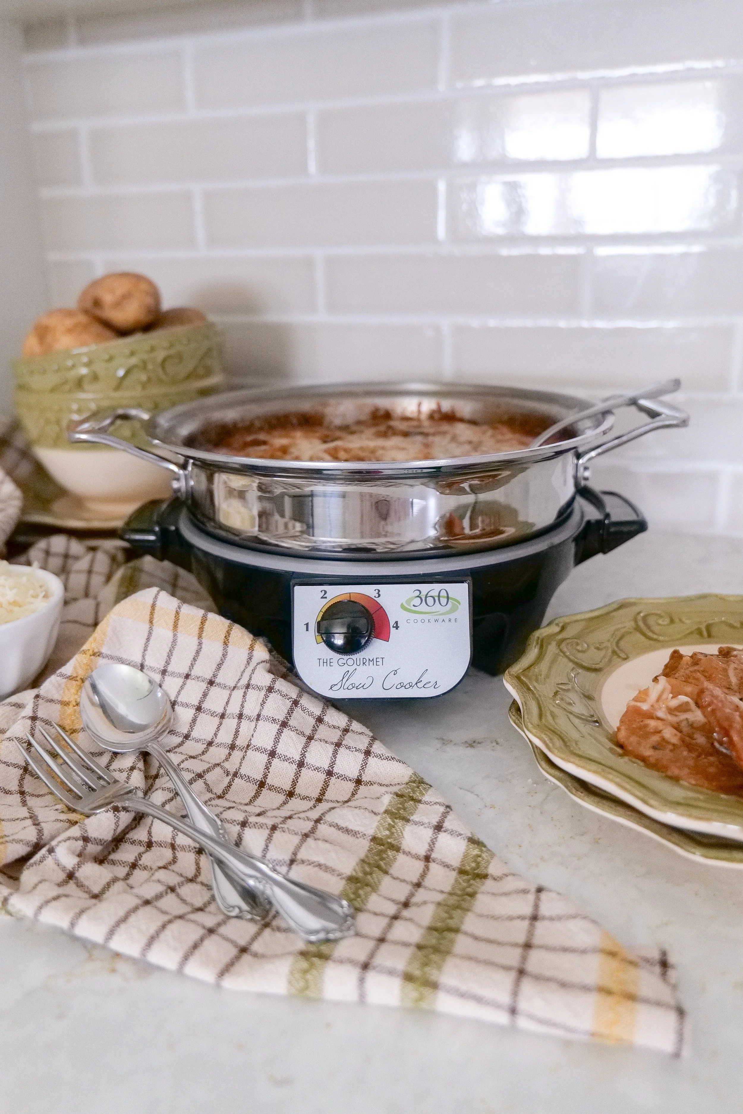 Slow cooker holiday side dish recipe with creamy scalloped potatoes.