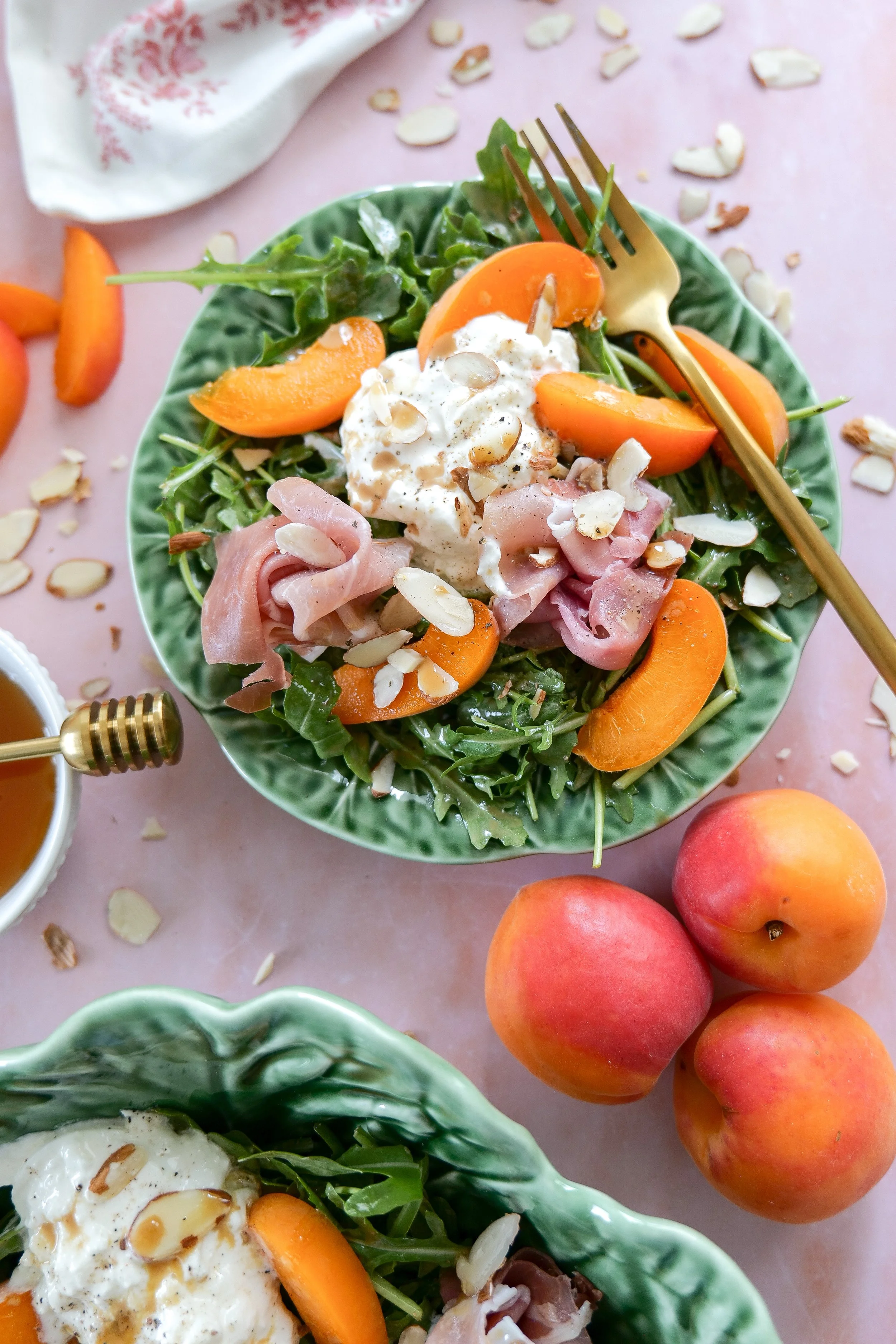 Burrata salad topped with honey balsamic dressing and almonds.