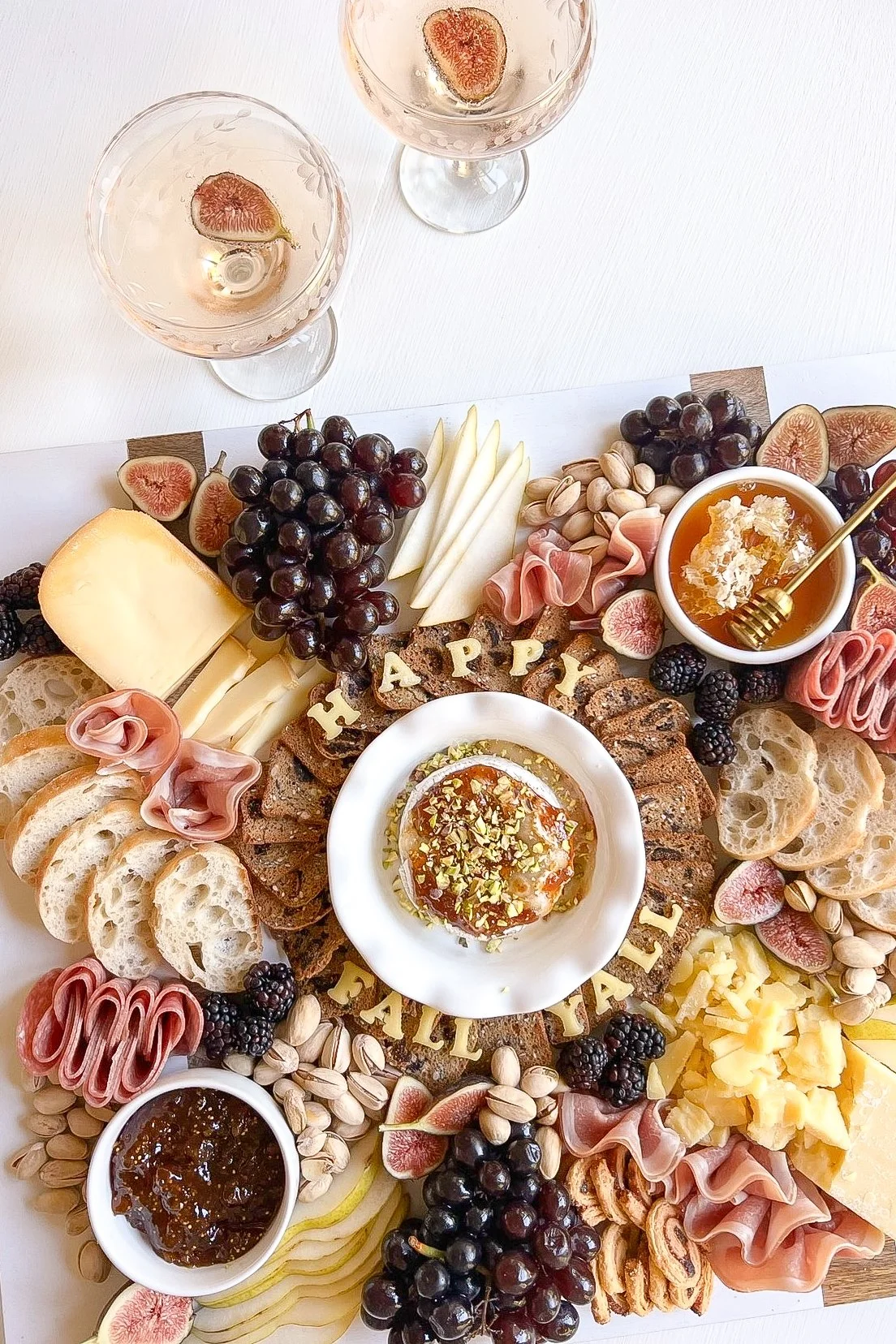 Fall cheese board with fresh figs, pears and red grapes