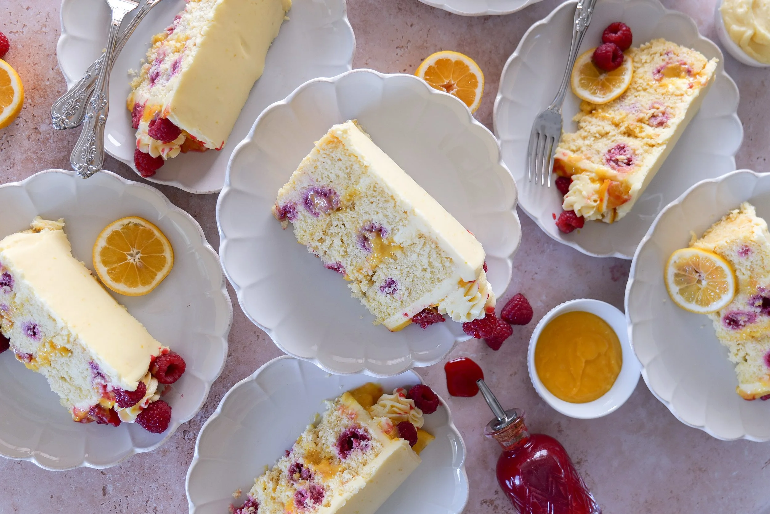 Raspberry filled lemon cake with soft sponge layers and frosting.