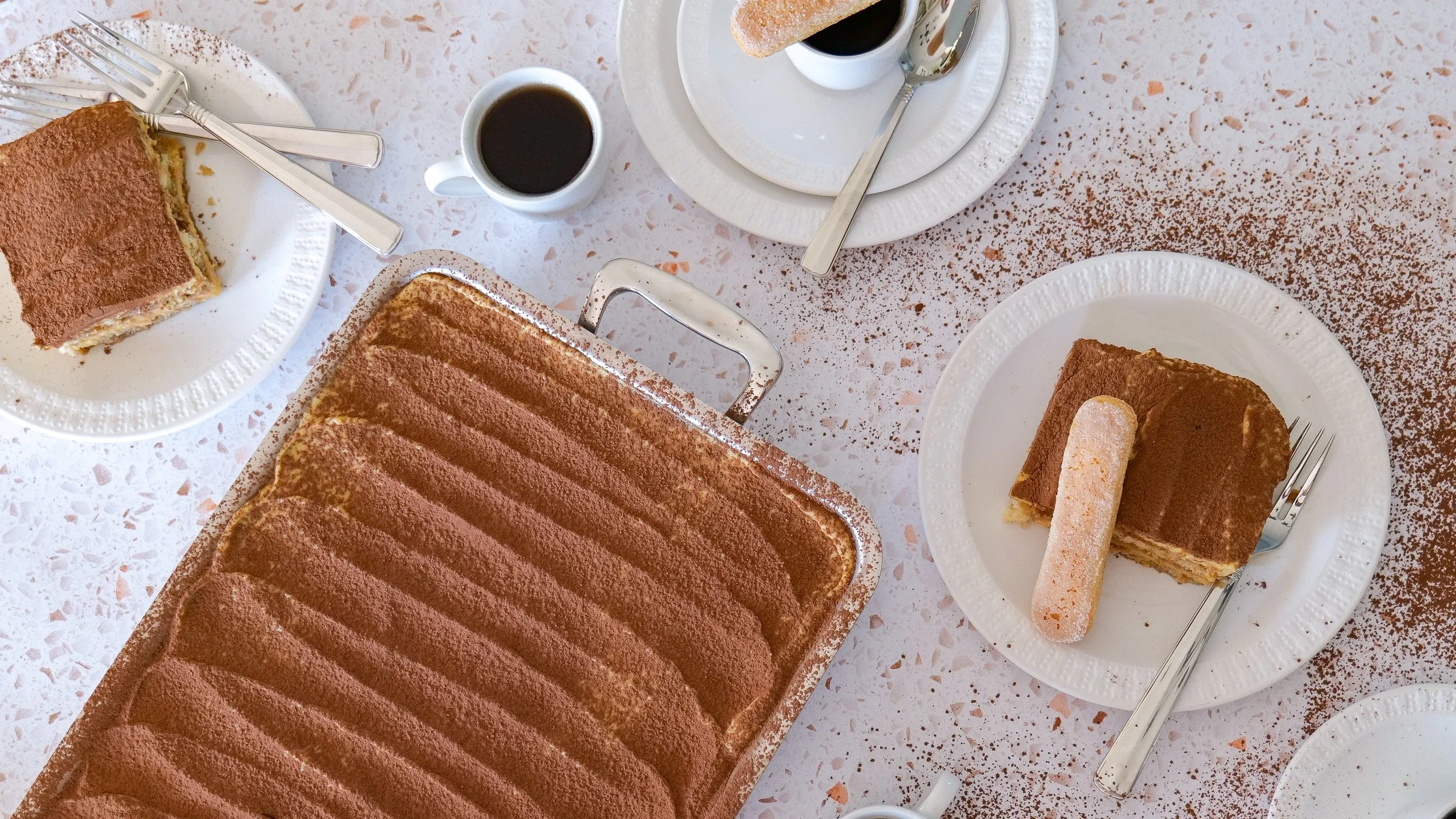 Close-up of pumpkin tiramisu showing layers of espresso-soaked ladyfingers and pumpkin mascarpone.