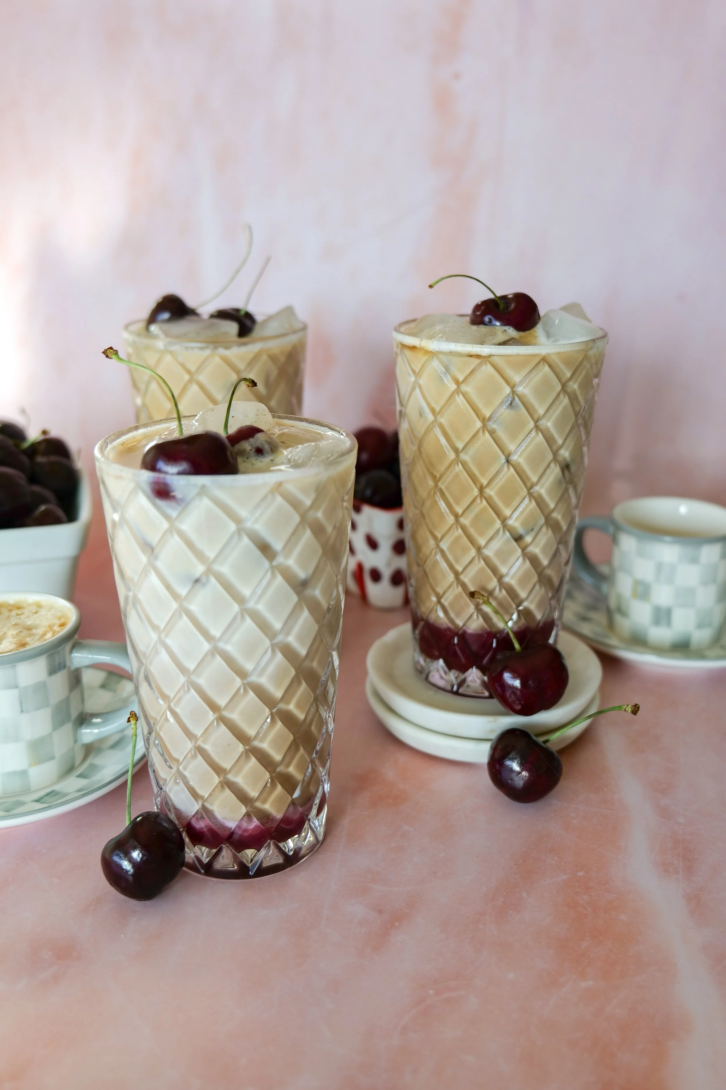 Easy summer coffee recipe featuring espresso, homemade cherry syrup, and creamy milk.