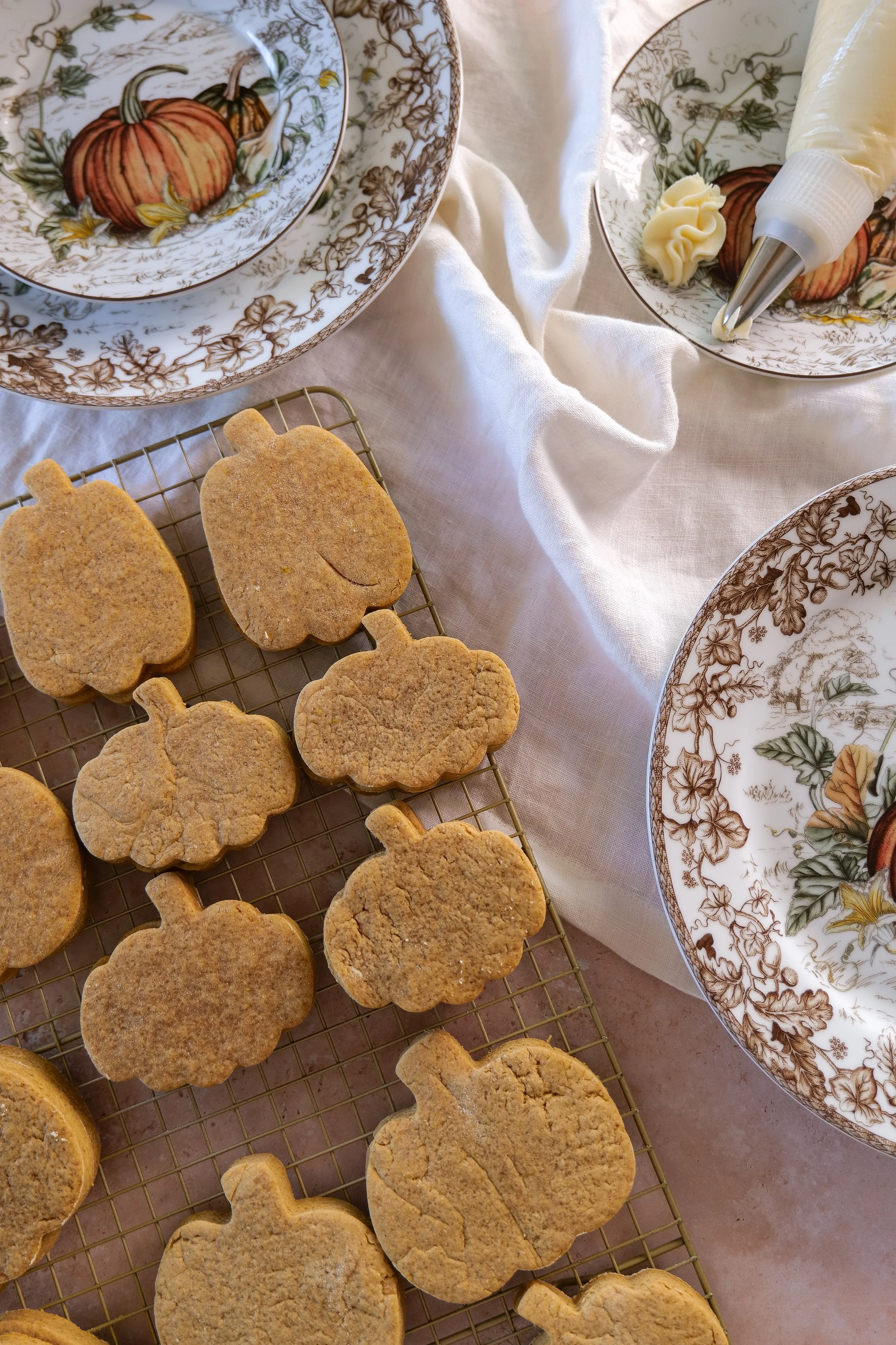 Soft baked pumpkin cutout cookies cooling after baking