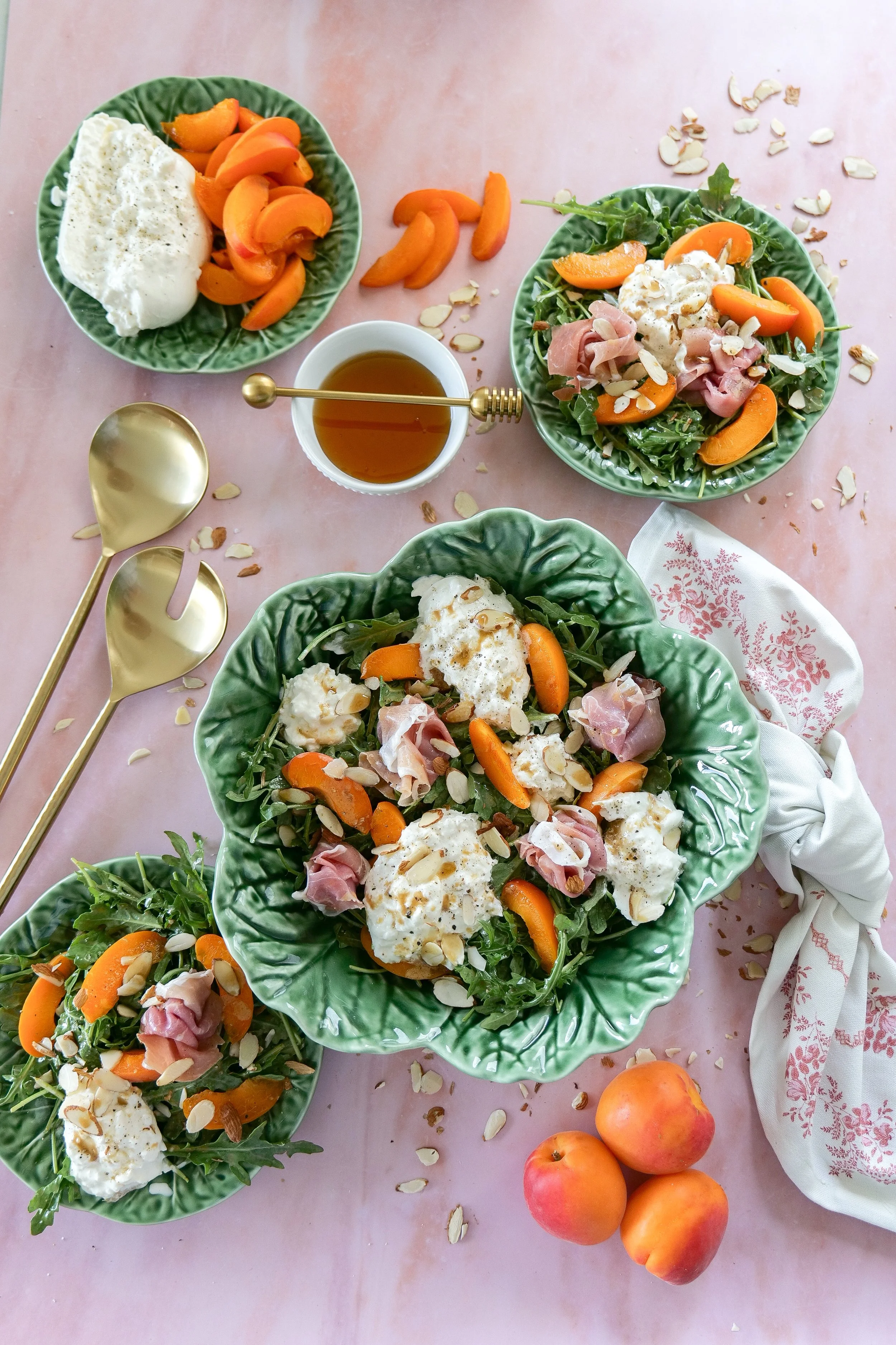 Fresh apricot salad served with creamy burrata cheese and greens.