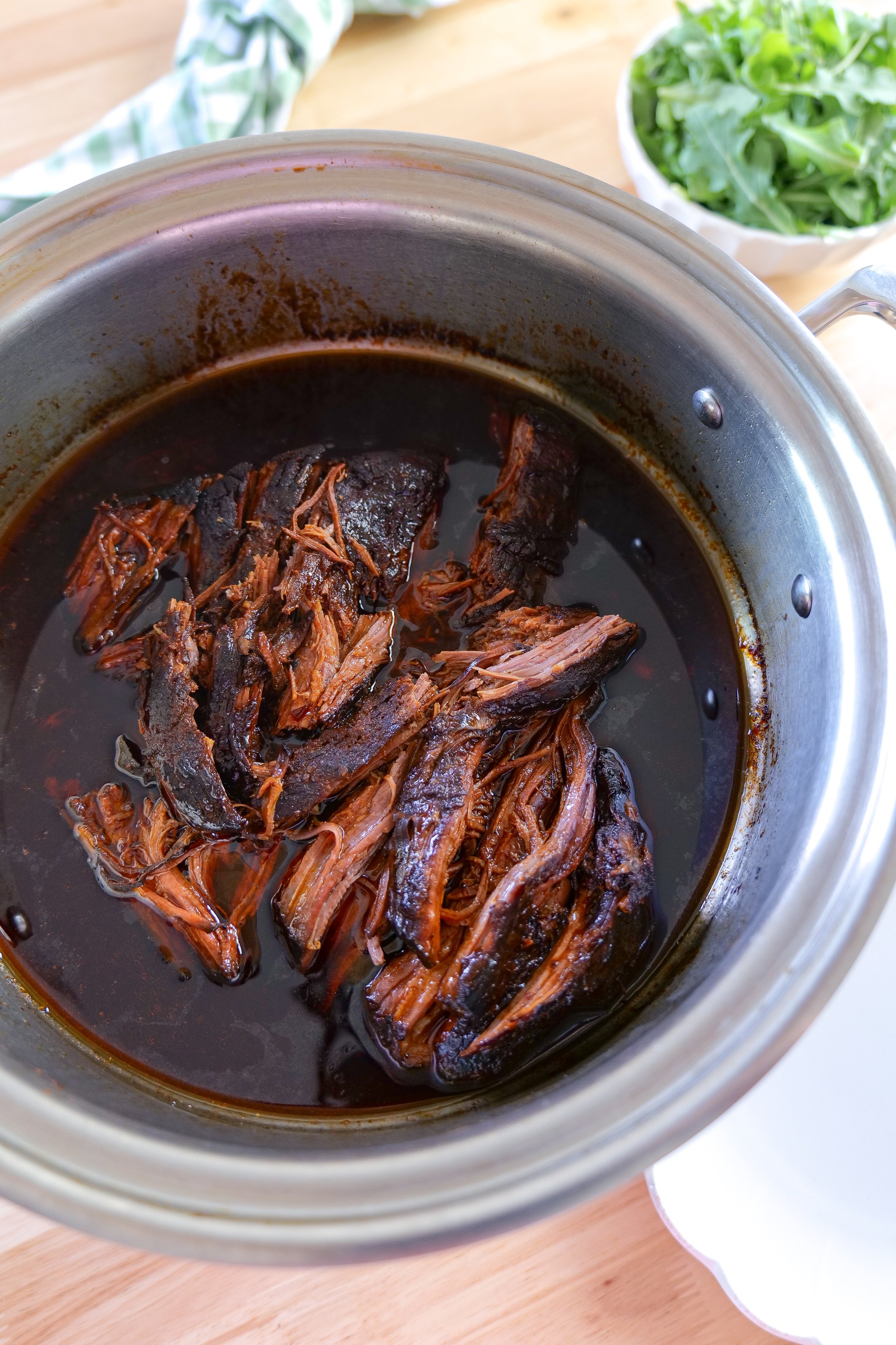 Juicy slow cooker brisket with tender shredded beef and BBQ sauce.