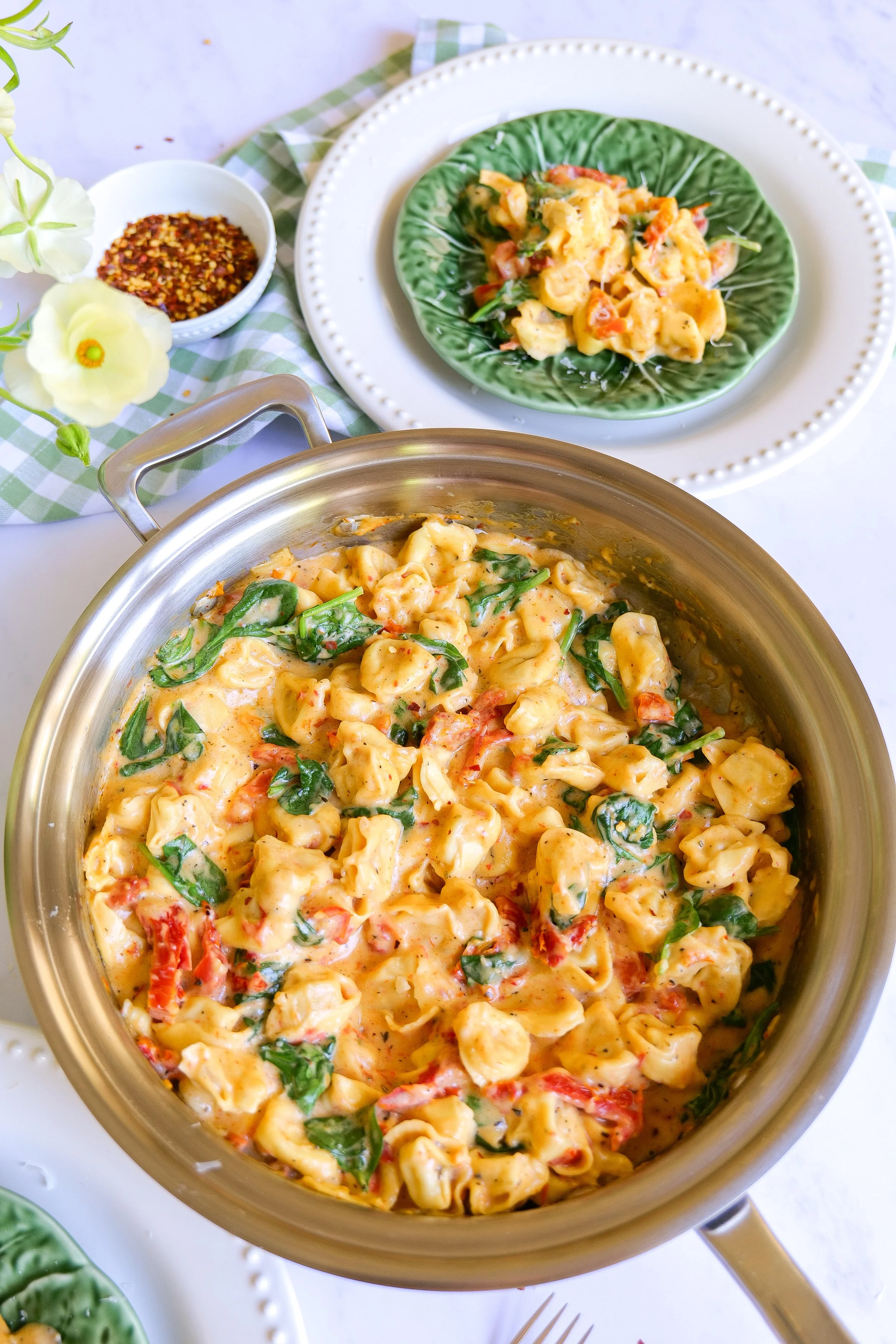Family-style serving of One Pot Marry Me Tortellini with Parmesan on top