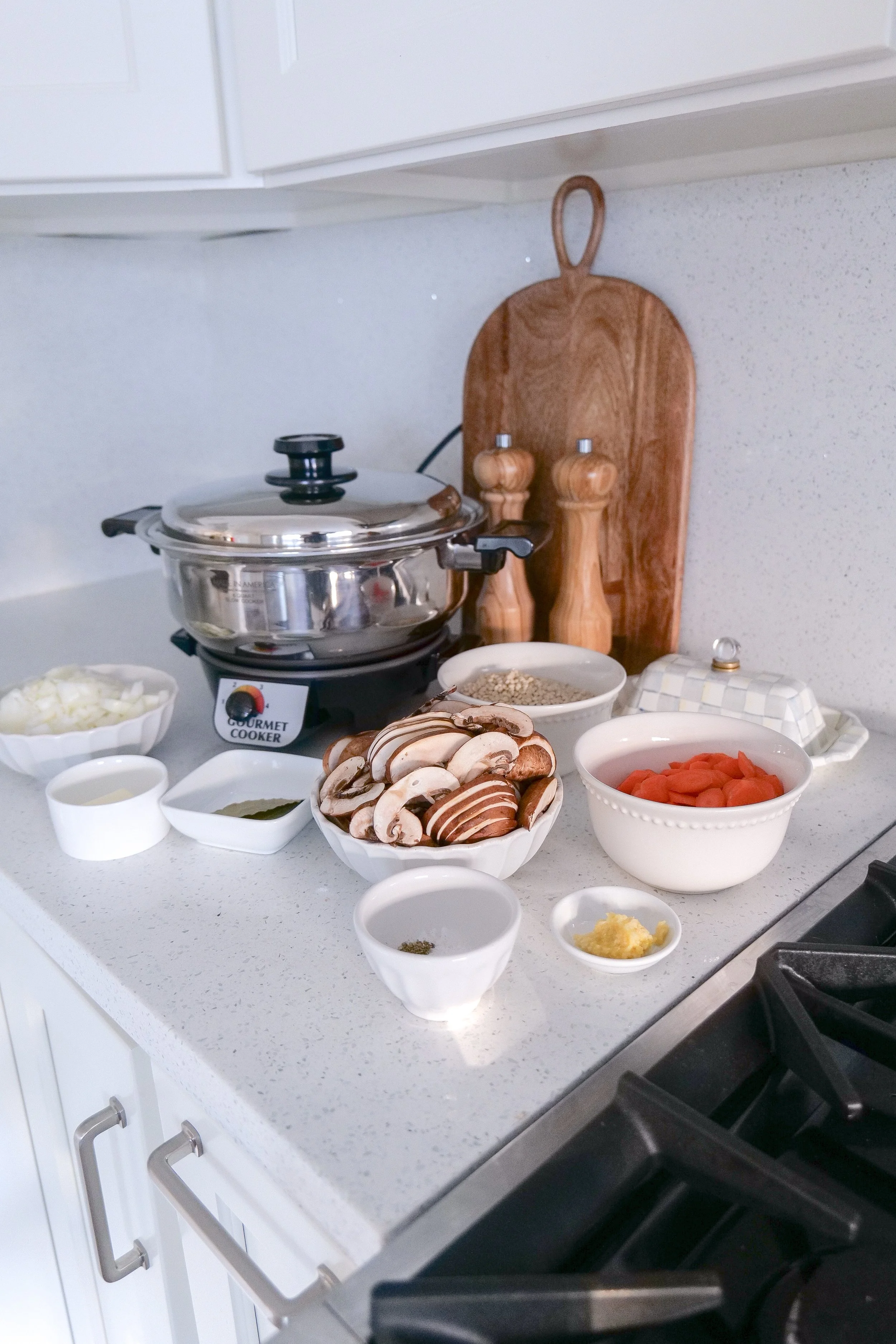 Ingredients for slow cooker chicken soup with mushrooms, carrots, couscous and herbs.
