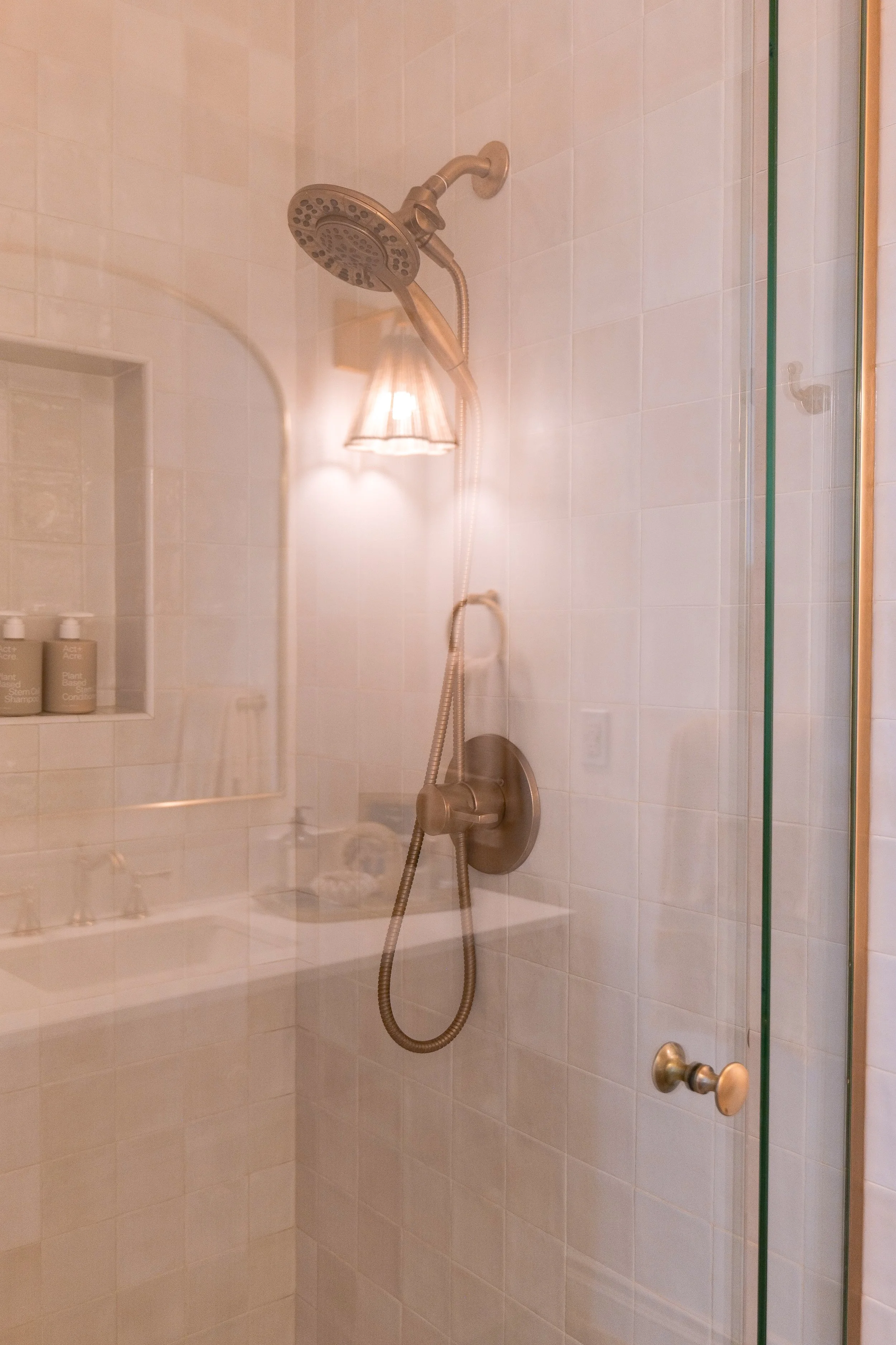 Widened shower entrance with a glass door in the remodeled bathroom.