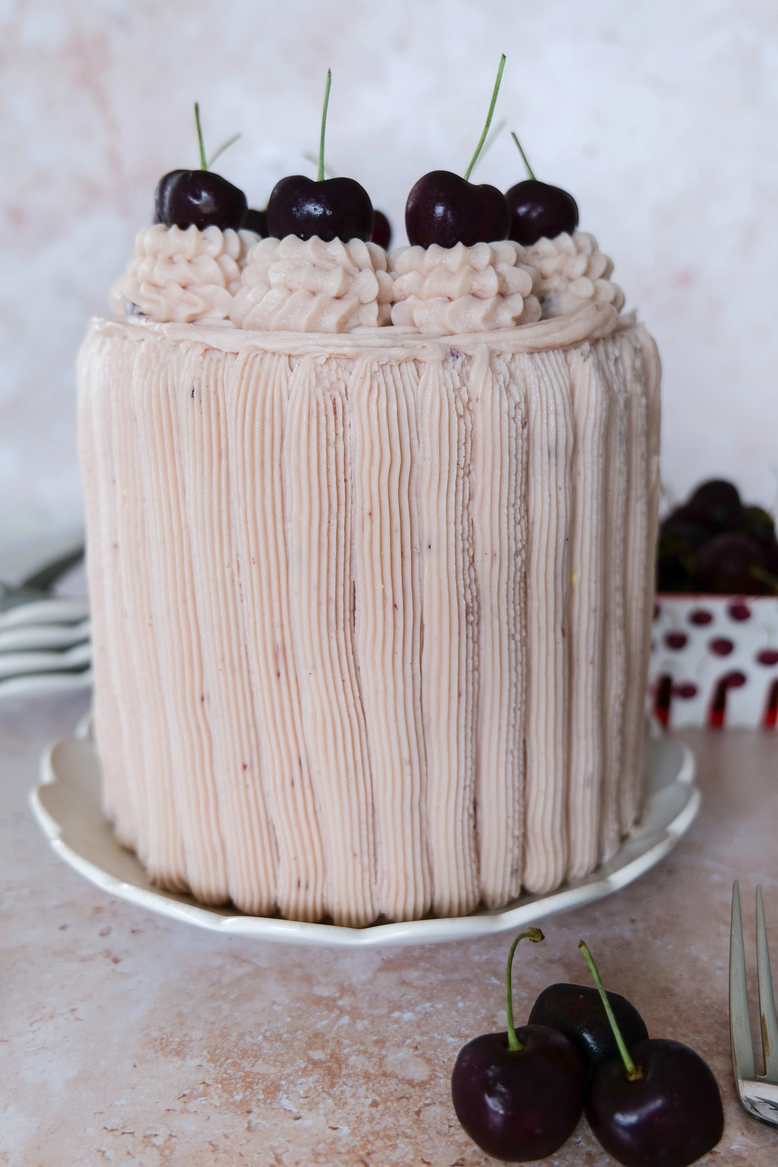 Elegant homemade cherry birthday cake with fluffy vanilla layers and fresh fruit filling.