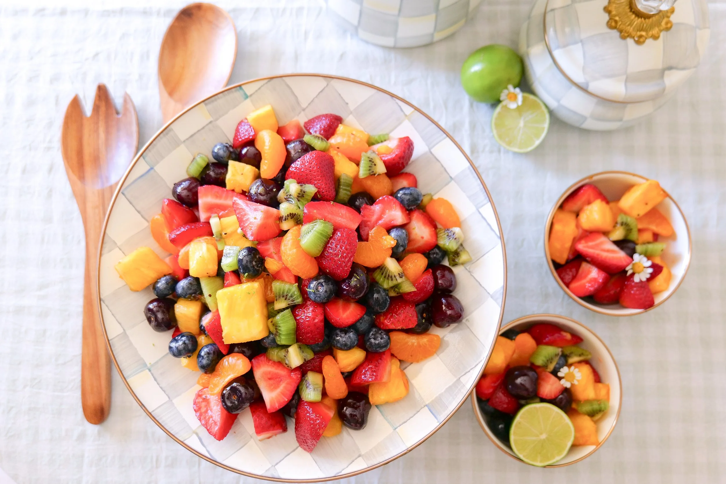 Honey lime fruit salad served in a large white bowl