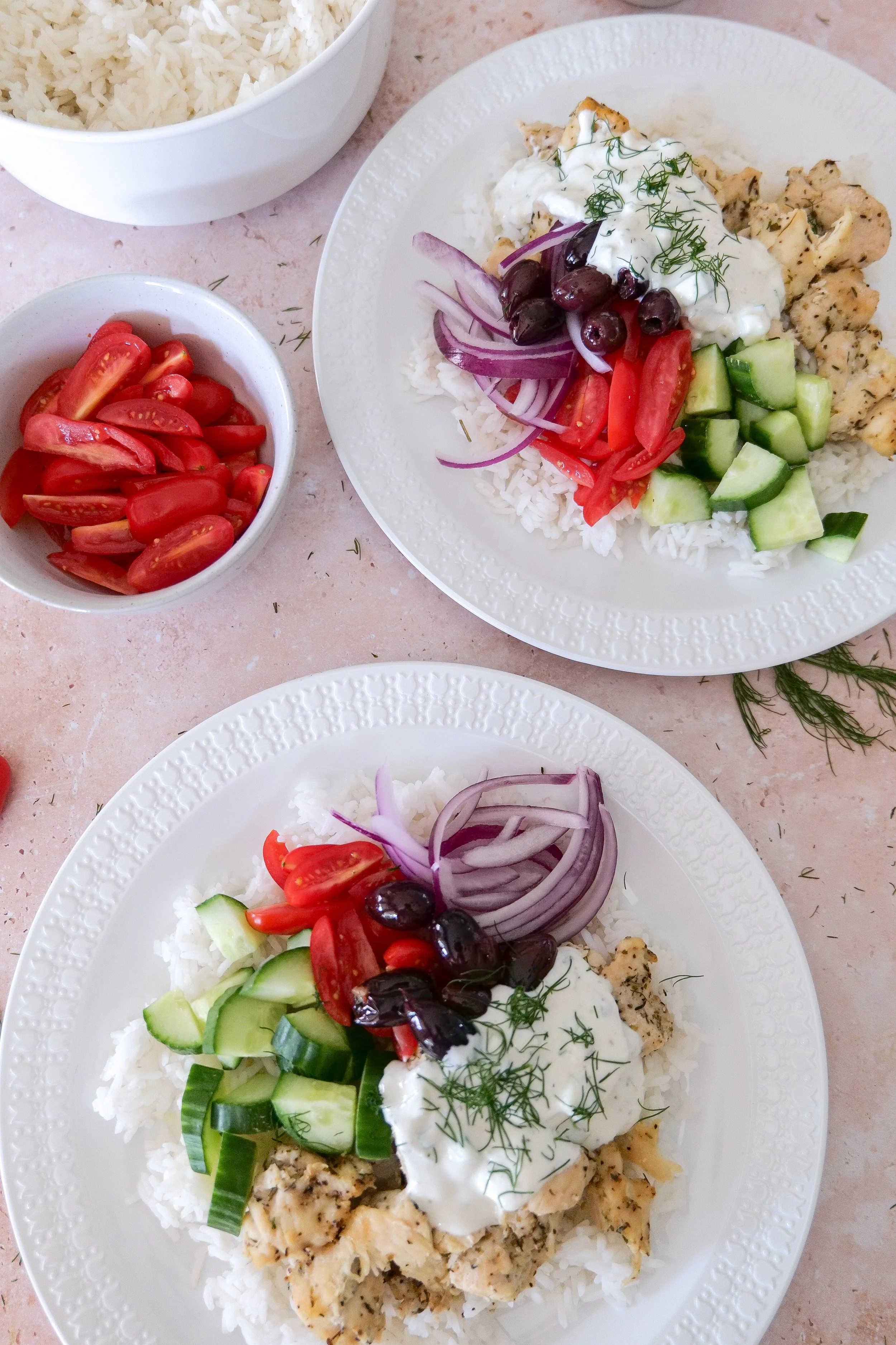 Herb-marinated chicken served over jasmine rice with fresh Greek-inspired toppings.