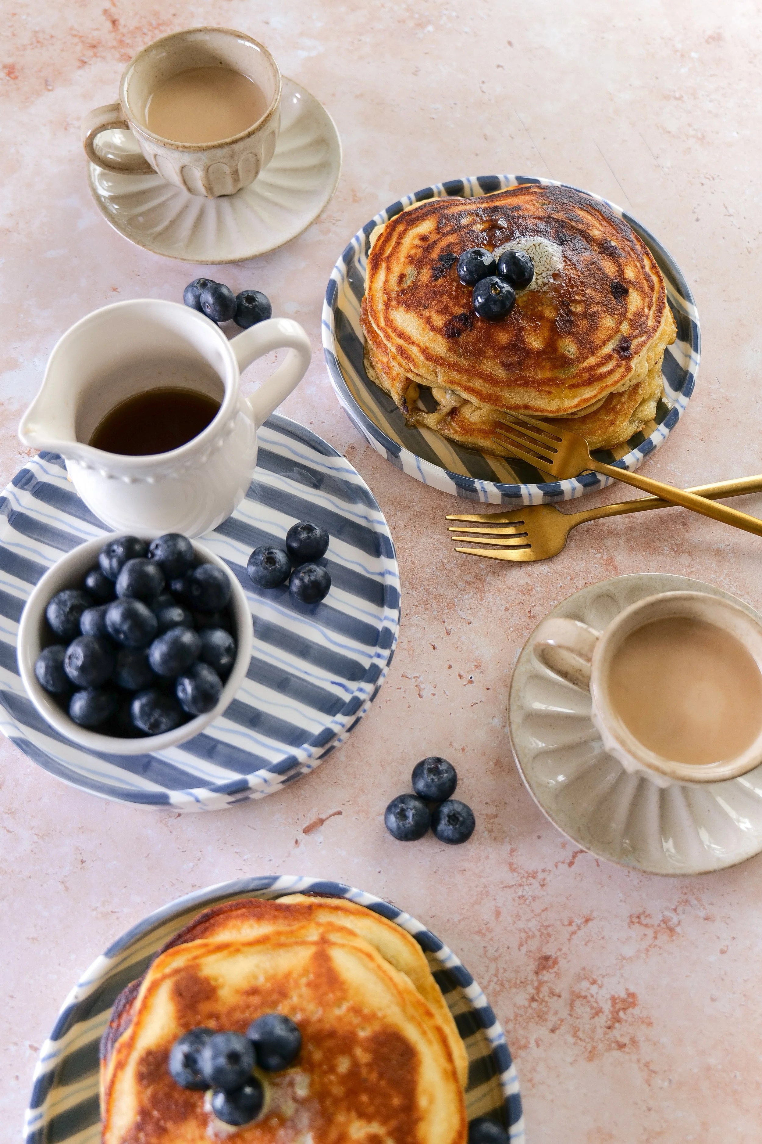 Homemade sourdough discard pancakes with blueberries and warm maple syrup.