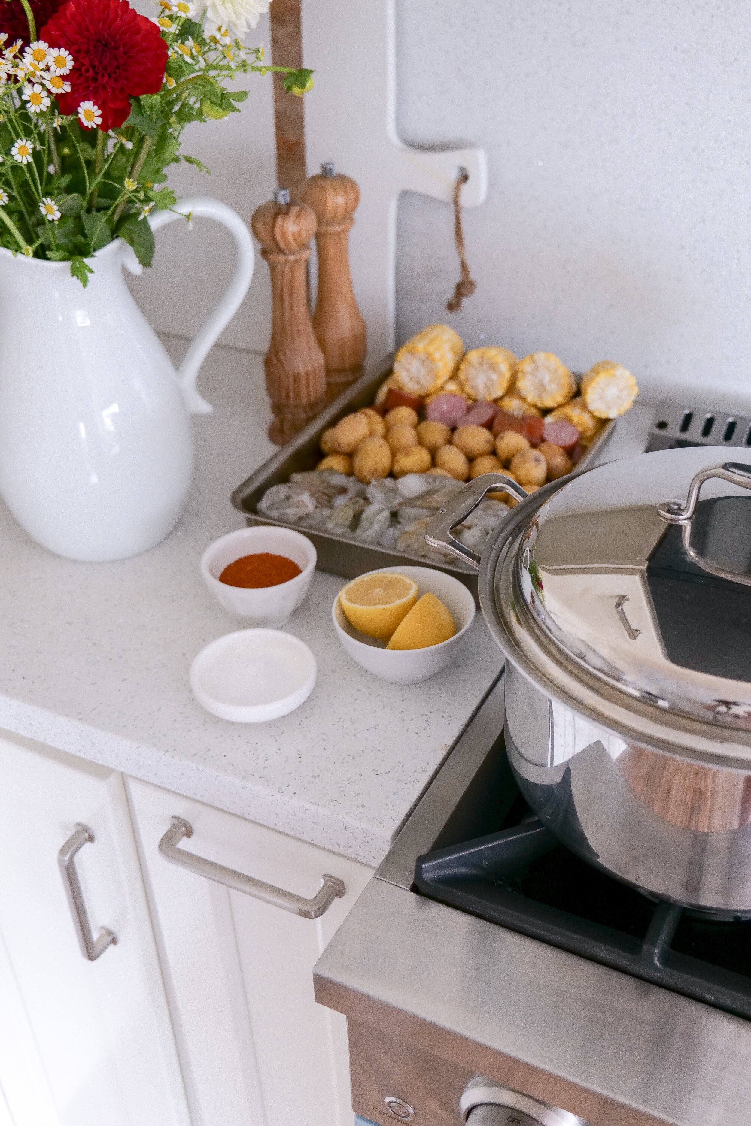 Family-style shrimp boil served for a backyard summer dinner