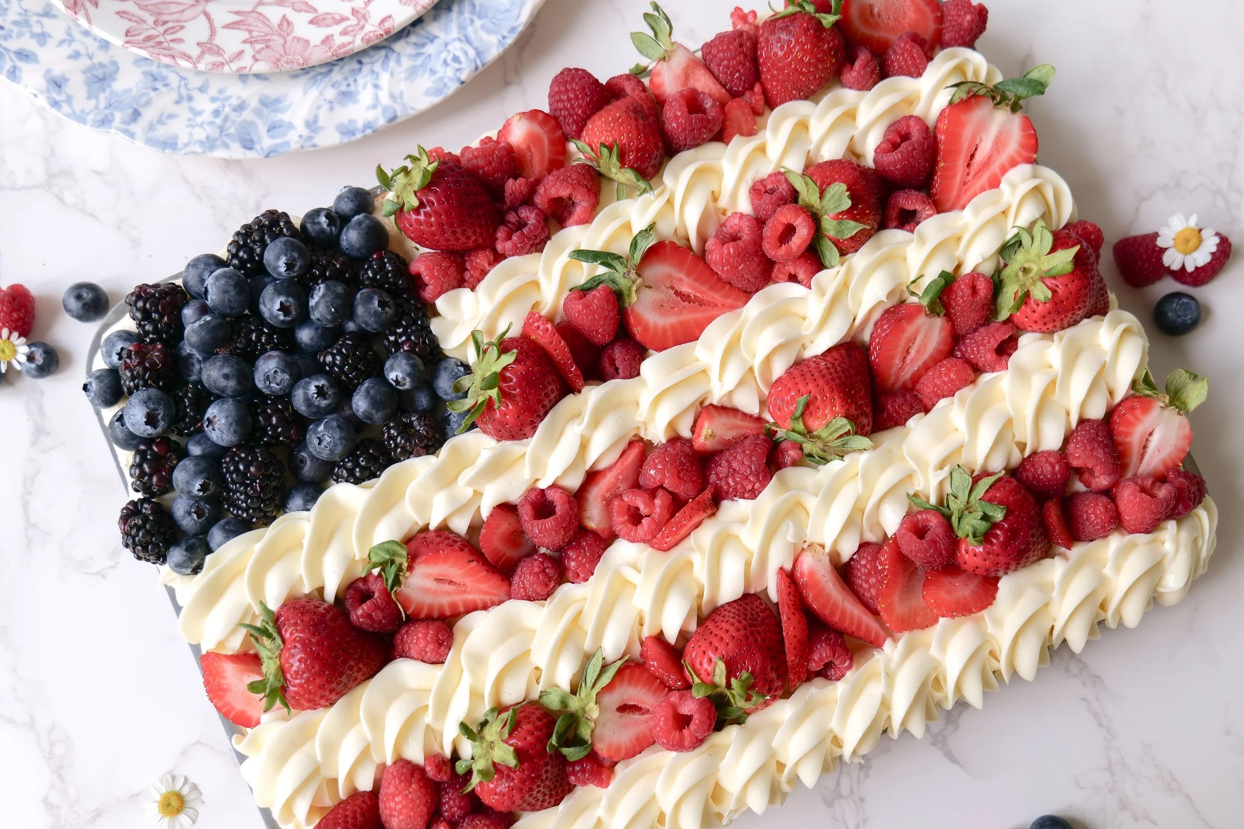 Patriotic 4th of July fruit pizza decorated like an American flag with strawberries and blueberries
