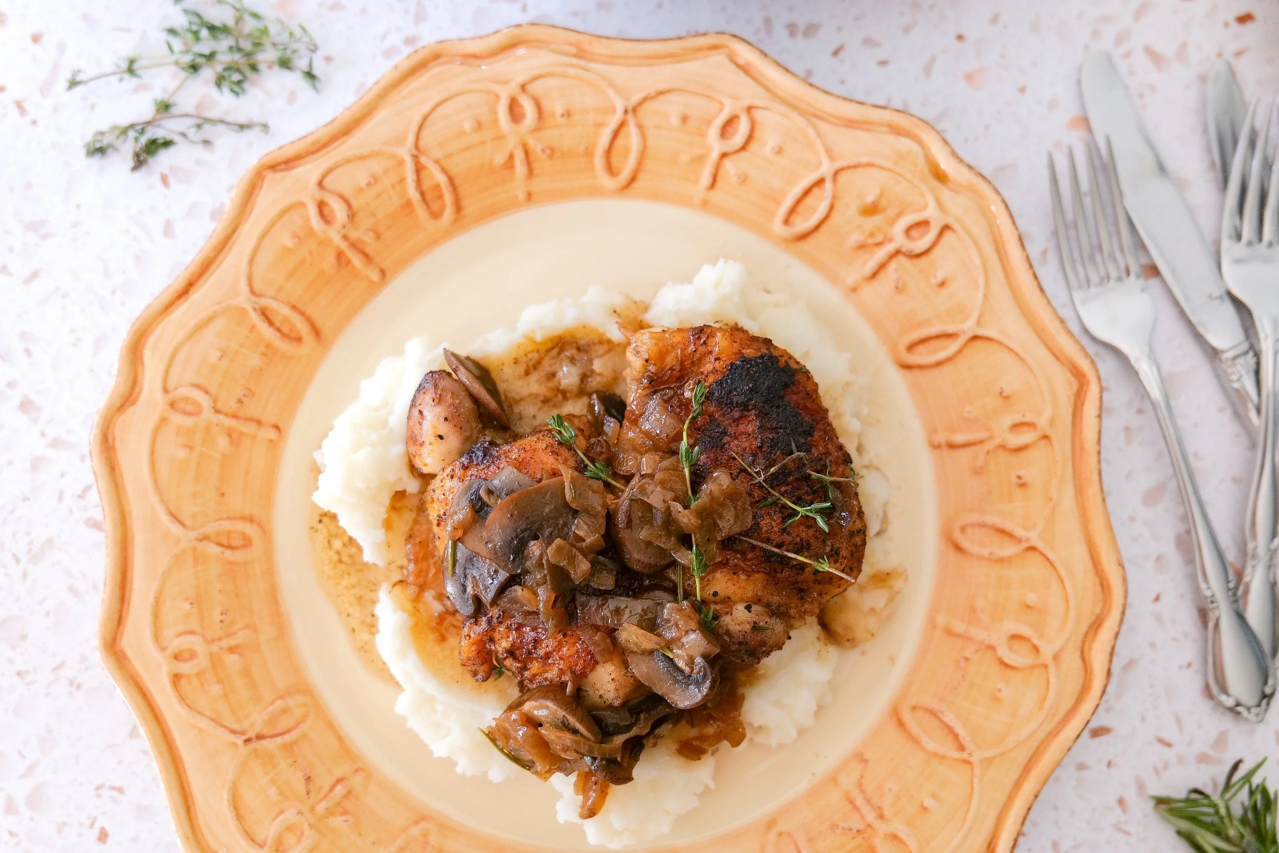 One-pan mushroom chicken thighs served in a savory herb pan sauce.