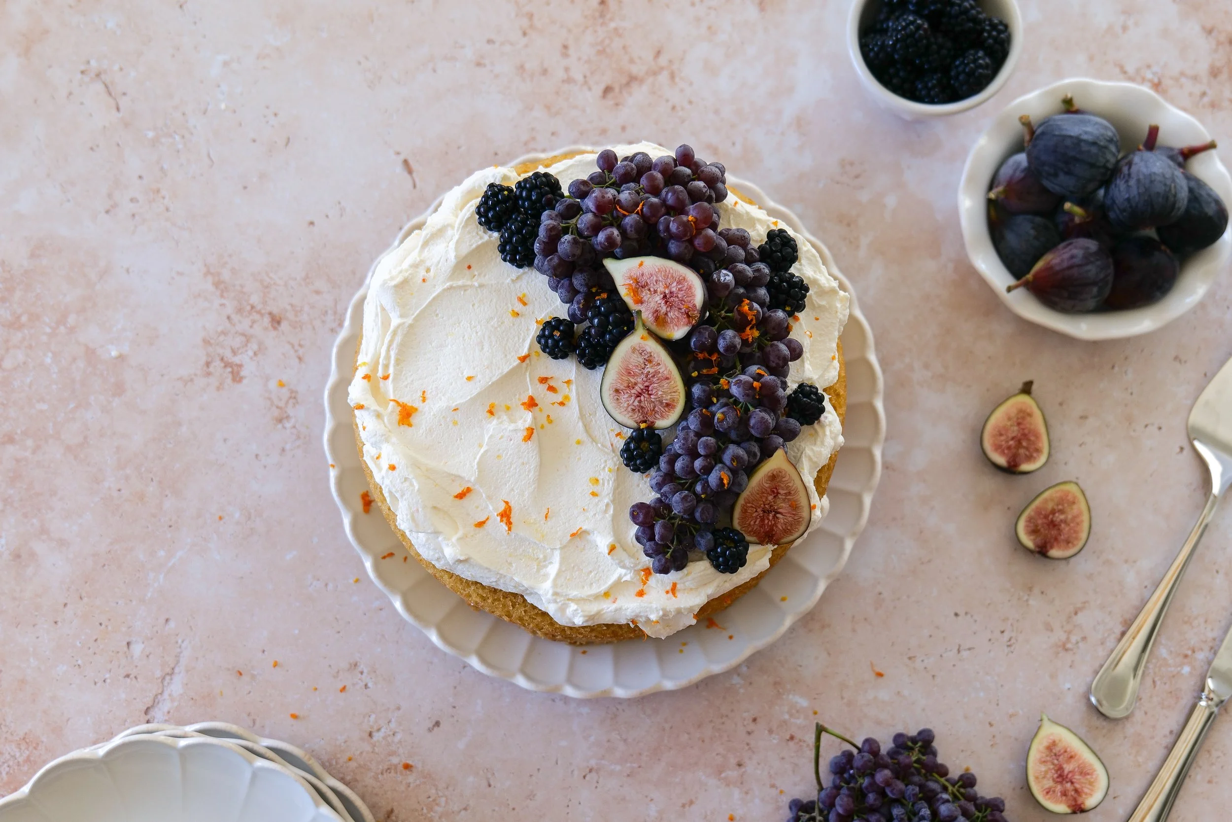 Homemade orange olive oil layer cake with mascarpone cream and seasonal fall fruit