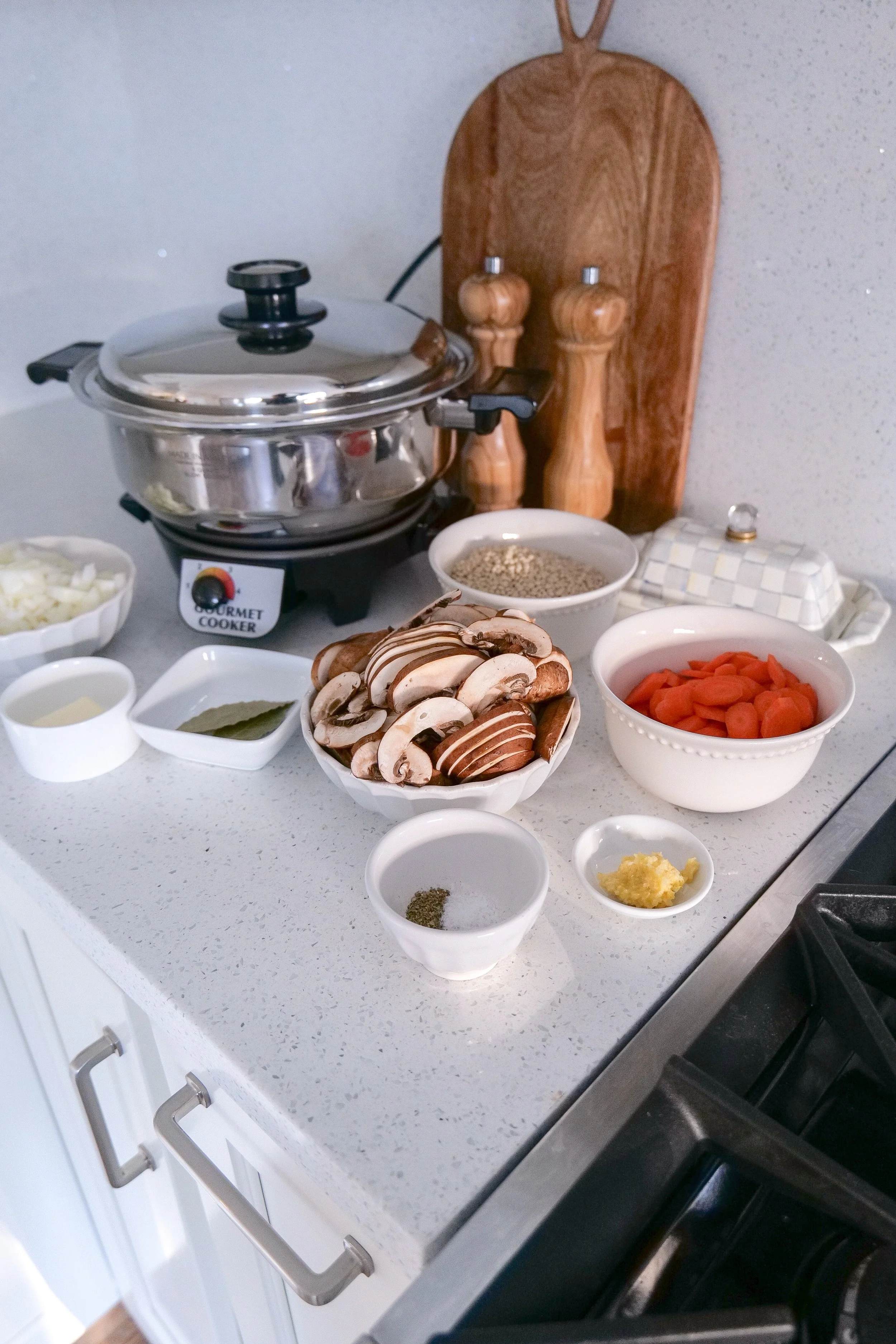 Ingredients for homemade chicken and mushroom couscous soup arranged before cooking.
