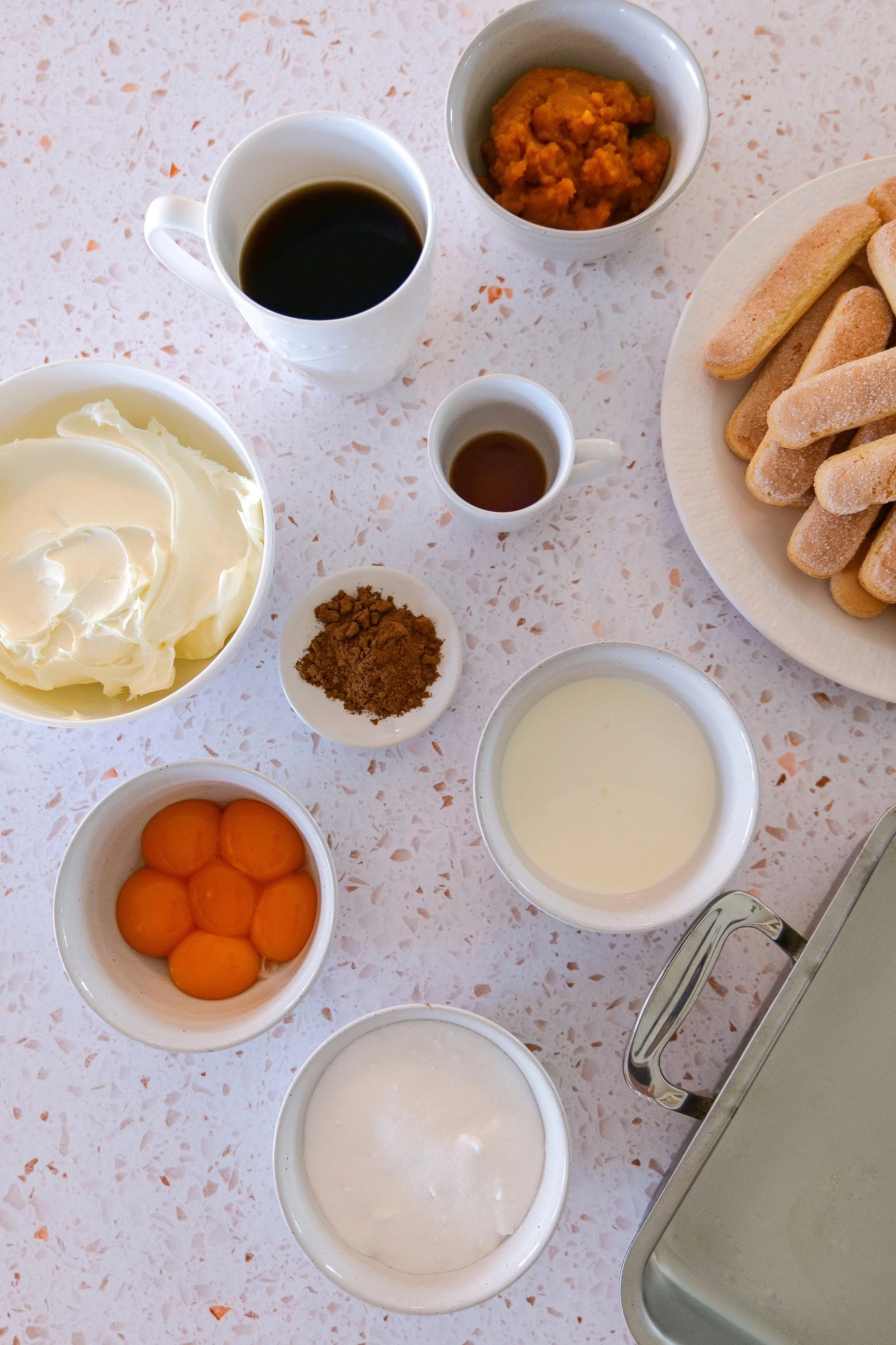 Ingredients for pumpkin tiramisu including mascarpone, pumpkin purée, espresso, ladyfingers and pumpkin pie spice.