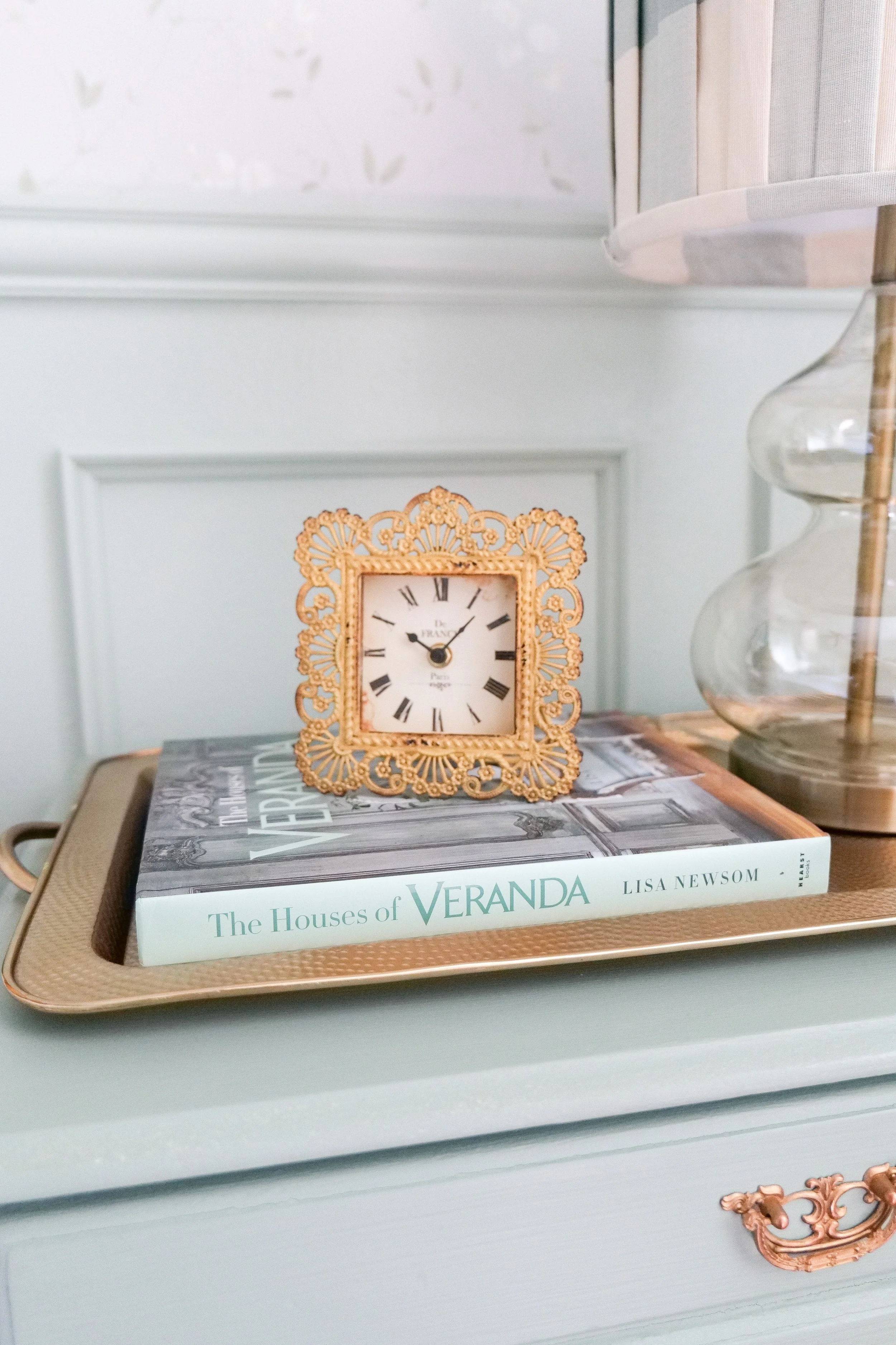 Traditional guest bedroom dresser styled with neutral decor and elegant accents.