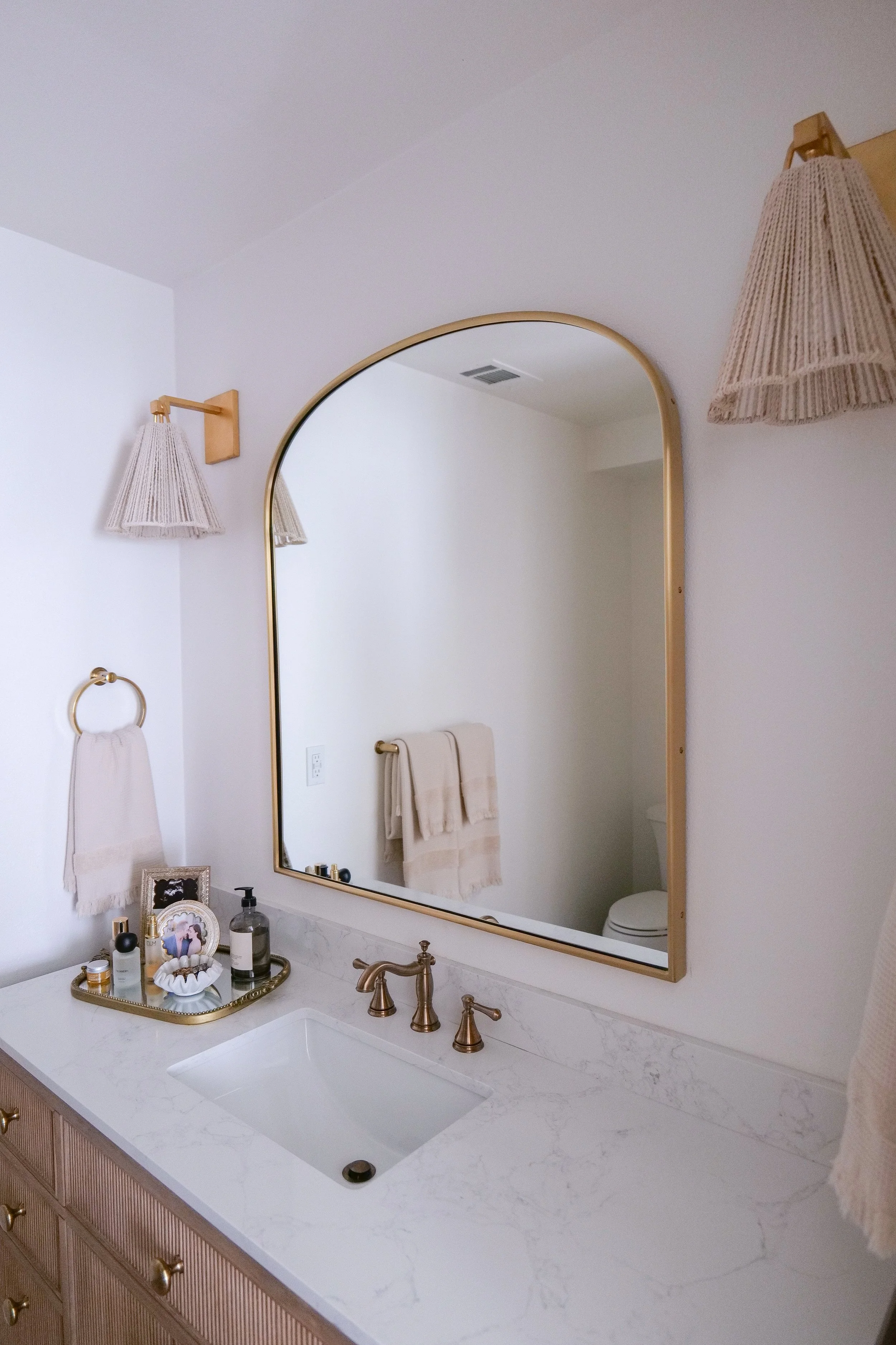 Rejuvenation bathroom mirror paired with Pottery Barn lighting with rope detailing.