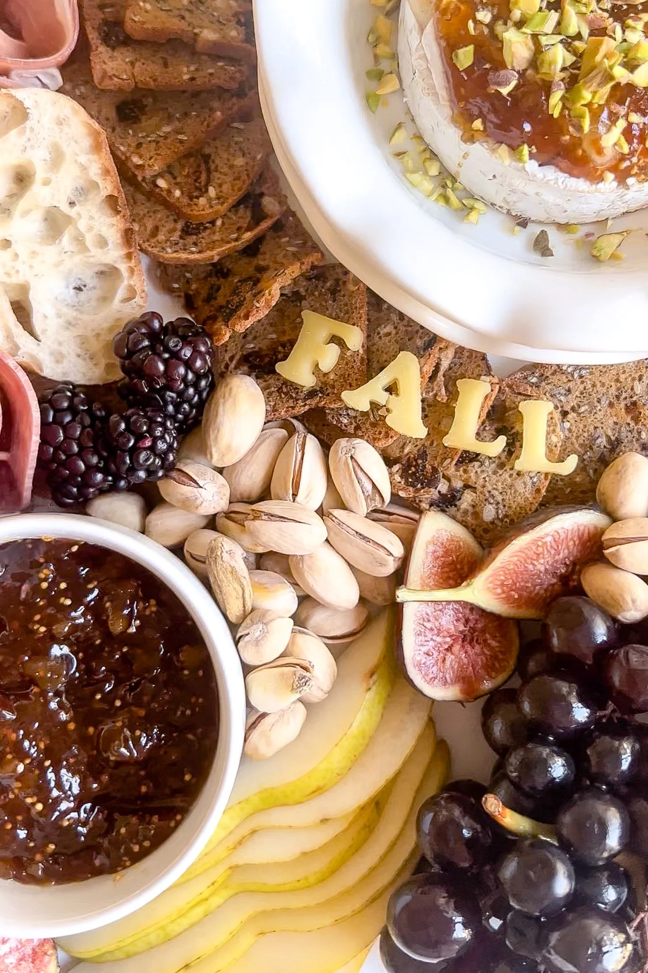 Baked Brie centerpiece on a fall charcuterie board