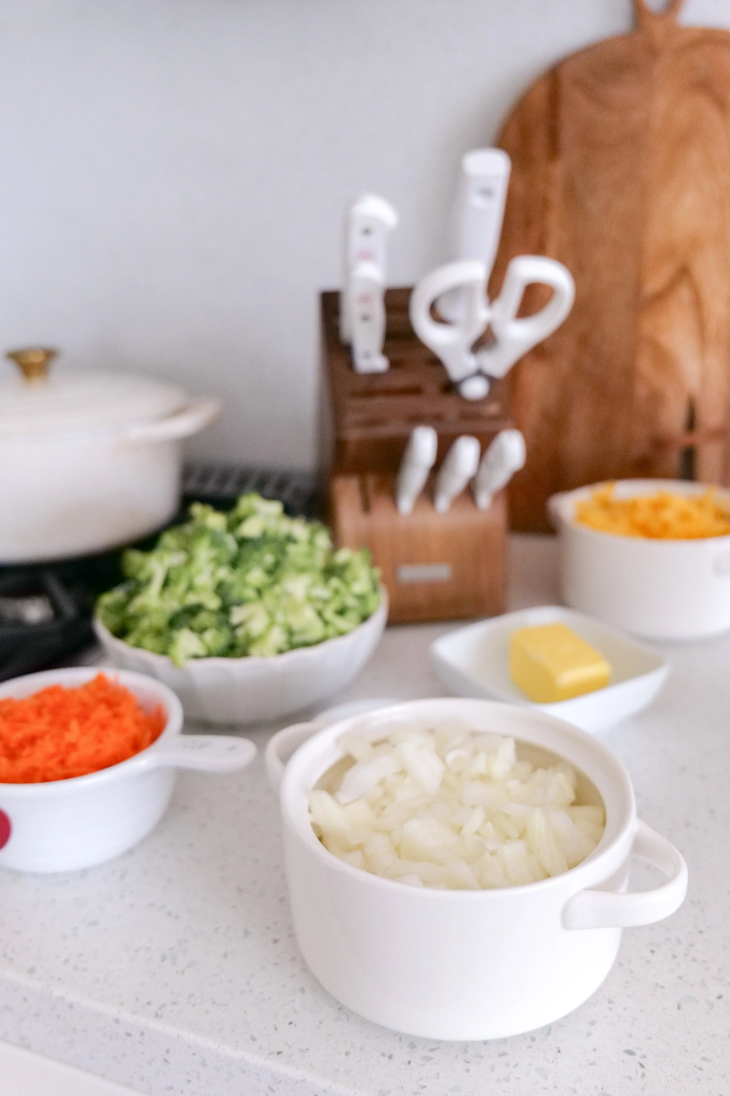 Broccoli, carrots, cheddar cheese and other ingredients for creamy broccoli cheddar soup.